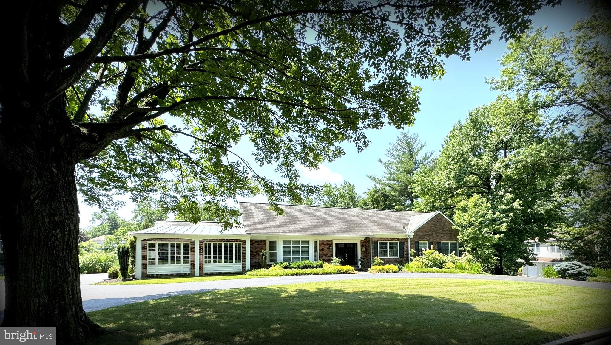 Welcome to 1017 Walsh Lane, a beautifully expanded brick Cape Cod nestled on a serene cul-de-sac street in the heart of Penn Valley. Set well back from the street on a lush, nearly 3/4 +/- acre lot, this impeccably maintained home offers the perfect blend of timeless character, modern amenities, & exceptional convenience just minutes from Center City, top schools, & all major roadways.
A circular driveway leads to the gracious double door Center Hall entrance. Inside, the home opens to an inviting Living Room with a large bay window & flowing into the formal Dining Room. French doors welcome you into a stunning vaulted-ceiling Sunroom with heated floors, bathed in natural light.
The Kitchen is a chef’s dream with custom cabinetry, a large island with granite counters, premium appliances & open to the Family Room with a cozy fireplace. Step outside to an awninged terrace, overlooking the sparkling pool & expansive patio perfect for summer entertaining.
The spacious main-level Primary Suite features dual walk-in dressing rooms & a spa-like bath with heated floors, oversized shower, soaking tub & private water closet. A second bedroom & hall bath with heated floors complete this level.
Upstairs, a bright lounge with wall of windows & skylights, built-ins & hardwood floors provides a versatile retreat. Two additional bedrooms, each with skylights, hardwood floors & generous closets, share a large hall bathroom.
The walk-out lower level is flooded with light & offers abundant living space including a media area, game area, powder room, plus extensive storage options including a cedar closet & laundry room.
Additional features include a 2-car garage, professional landscaping & a quiet, tree-lined street in the award-winning Lower Merion School District.
This warm & welcoming home combines elegance, comfort & location in a way that’s rarely available don’t miss your opportunity to make it yours!