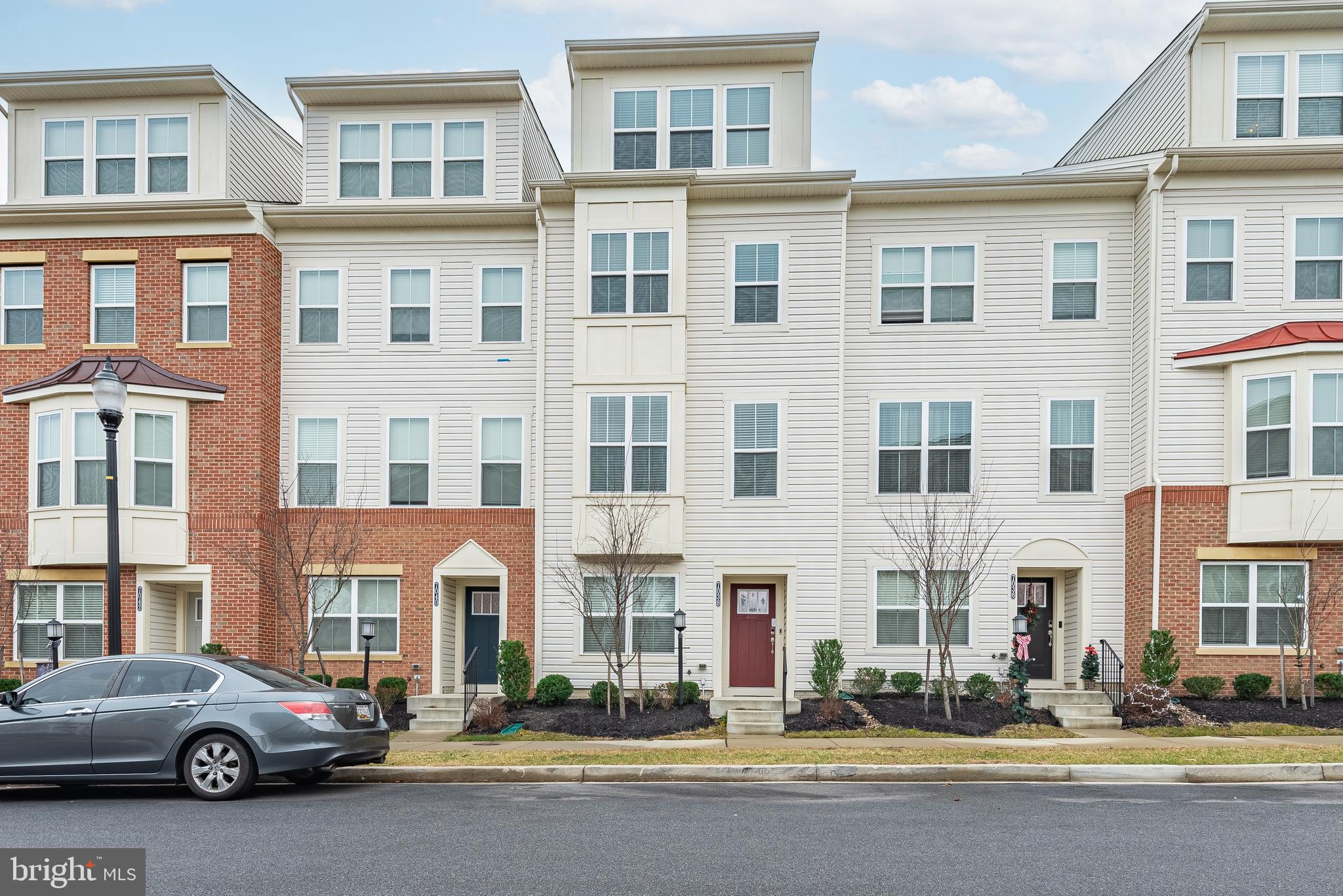 NEW PRICE! This gorgeous 4 level garage townhome features 4 bedrooms/4.5 baths. Main level design is open with ample space for entertaining including living room and dining area with slider to deck and kitchen with granite countertops, island and breakfast bar. First upper level includes two bedrooms, each with private bath. Primary bath includes dual vanities and walk-in shower. Second upper level offers additional bedroom with private bath and loft/family room opening to terrace. Fourth bedroom with private bath and large laundry room located on lower level. Oversized garage with driveway in rear of property. This home also features smart lock and thermostat. Newer community with schools, easy access to transportation and shopping!