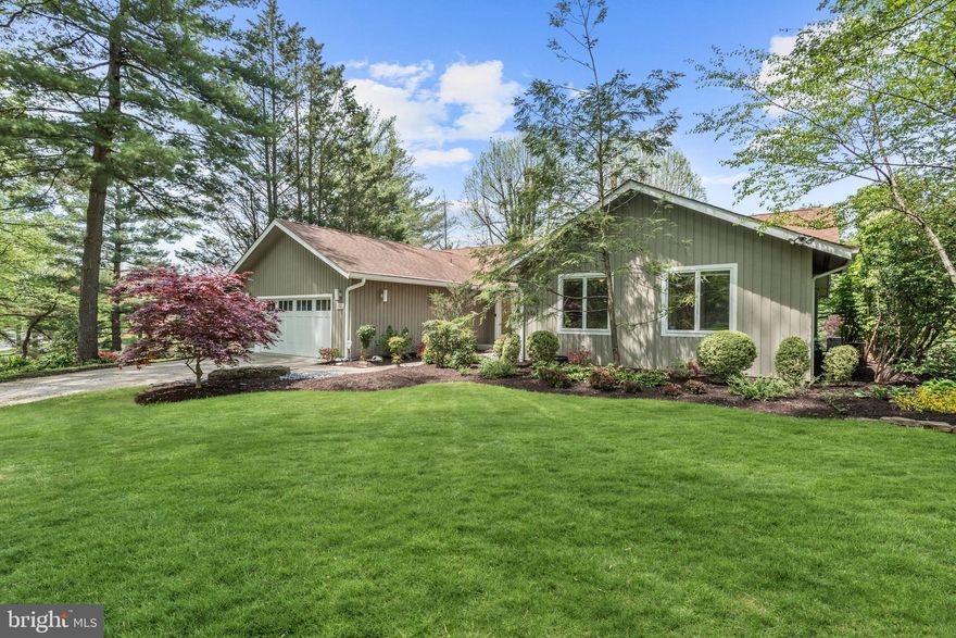 Positioned along the first hole in highly sought-after Hobbits Glen, this extraordinary single-level residence offers a rare opportunity for a lifestyle that is both sophisticated and effortless. Ideally situated and architecturally distinctive, this enclave of custom homes blends natural beauty with resort-style amenities with the golf course literally steps from your door.  Hobbits Glen is more than a neighborhood; it is a destination. The par-72 championship course winds through Maryland timber and has hosted multiple Champions Tour events over the years. The beautiful clubhouse is home to The Turn House, a beloved farm to table restaurant offering breathtaking views, outdoor dining, and a fire pit. A driving range, practice areas, pro shop, swimming pool, tennis courts, playground, winding wooded trails through the adjoining nature preserve, and regular Columbia Association community events further enrich the experience.
A striking glass double-door entry opens to a dramatic skylit foyer with cathedral ceilings, immediately revealing sweeping fairway vistas beyond. The expansive living and dining are bathed with light by oversized windows that frame spectacular views. Refinished hardwood floors (2021) are featured in the foyer, adjoining den, living and dining room and hallway. Updated Anderson windows, generous recessed lighting, and full-wall floor-to-ceiling solid wood built-ins in the family room and formal dining area create architectural presence, while a statement gas fireplace anchors the living room. 
The spacious kitchen features updated quartz countertops (2021), under-cabinet lighting, stainless steel appliances including a double oven, updated refrigerator and dishwasher (2021), and porcelain tile flooring. Adjacent, a heated solarium offers year-round space perfect for nurturing greenhouse plants. Upgrades include a fully renovated laundry room (2022) with a new washer and dryer, custom cabinetry, a butcher block counter for folding laundry, and an upgraded stainless sink.
The primary suite is a serene sanctuary with hardwood floors, custom cedar closet shelving and a fully renovated spa bath (2022) featuring high-end German Hansgrohe fixtures, a beautifully tiled shower with frameless glass door, and a solid wood vanity with farmhouse sink and stone countertop. The second full bath (2025) is equally luxurious, with Carrara marble floors, a frameless glass tub-shower enclosure with wood-look tile for a spa-like ambiance, and a solid wood vanity with farmhouse sink and stone countertop.  Additional bedrooms and the staircase to the lower-level feature high-end Anderson Tuftex carpeting (2021). The finished lower level expands your living possibilities with a generous recreation room featuring engineered wood floors, a fourth bedroom with new carpet (2021), media wiring, and abundant storage—ideal for guests, hobbies, or extended stays. Extensive updates include new HVAC (2021), water heater (2021), fresh interior paint (2021), and refinished hardwoods (2021) and ensure true move-in readiness.
Outdoors, Japanese gardens-inspired landscaping surrounds the home, with flowering plants curated to bloom from early spring through late fall. A stone patio, wood deck, and dedicated fire pit platform harmonize beautifully with the fairway backdrop and offer spectacular sunset views.  Equally remarkable is the robust community with monthly happy hours at the clubhouse and frequent gatherings that foster a genuine sense of belonging. Beyond the greens, Downtown Columbia and the vibrant Merriweather District are just minutes away, offering world-class restaurants and the iconic Merriweather Post Pavilion. Beloved local farms are nearby, and quick access to Baltimore, Washington, and major highways ensures seamless regional connectivity. This amazing property offers resort living, architectural distinction and harmony with nature. Welcome home into a lifestyle like no other in Hobbits Glen.