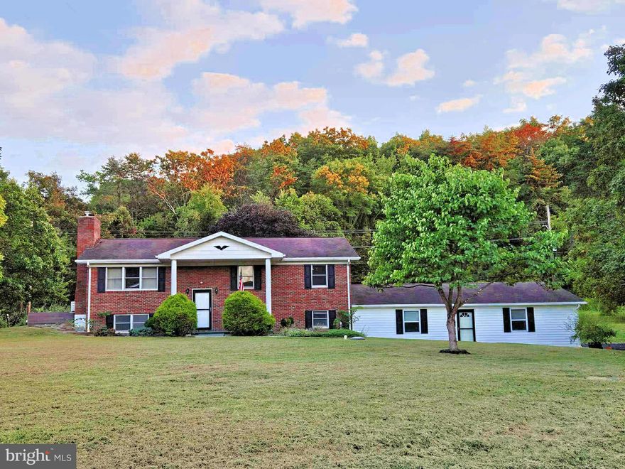 PRICE REDUCED! EXQUISITE 2288 SQ FT. BRICK SPLIT FOYER WITH AN ENORMOUS 960 SQ FT.  ATTACHED GARAGE ON 1.47 UNRESTRICTED ACRES!!!!  THIS 5 BEDROOM, 2 FULL BATH, BRICK HOME WILL TAKE YOUR BREATH AWAY, IT HAS ALL THE EXTRA'S, FRESHLY SEALED ASPHALT DRIVEWAY, RETAINING WALL, GORGEOUS SIDEWALK, EXTENSIVE LANDSCAPING, HARDWOOD FLOORS, NEW CARPET, CENTRAL HEAT/AIR, ELECTRIC BASEBOARD FOR BACKUP, A PANORAMIC VIEW OF THE FALL FOLIAGE SWEEPING ACROSS THE BEAUTIFUL WV MOUNTAINS, A SPRAWLING WRAP AROUND DECK, GORGEOUS PLANTS AND SHRUBS SCATTERED ACROSS THE ENORMOUS BACK YARD, BUT MOST IMPORTANTLY YOU CAN EXPERIENCE THE FREEDOM OF UNRESTRICTED OWNERSHIP, NO H.O.A!!!! THIS HOME FRONTS ON RT 50 A STATE MAINTAINED ROAD, BUT THE TREES AND NATURAL CONTOUR OF THE LOT GIVE YOU ALL THE PRIVACY THAT YOU COULD DESIRE. THE HOME HAS HARDWOOD FLOORS THROUGHOUT THE ENTIRE UPPER LEVEL, NEW CARPET WAS INSTALLED IN THE LARGE FAMILY ROOM ON THE LOWER LEVEL WHICH ALSO SPORTS  A  BEAUTIFUL BRICK FIREPLACE. THERE IS A NICE KITCHENETTE IN THE LOWER LEVEL AS WELL AS A FULL BATH, THAT WOULD BE IDEAL FOR TEENAGERS OR POSSIBLY A LIVE IN PARENT. THE ATTACHED GARAGE HAS TWO BAYS, AND WILL ACCOMIDATE 4 VEHICLES EASILY, IT ALSO HAS A GARAGE ENTRY INTO THE MUD ROOM/LAUNDRY ROOM, THE PERFECT SETUP! THERE IS A 12X12 OUTBUILDING, AND AN 8X16 OUTBUILDING FOR EXTRA STORAGE. THE PILLARS AND THE BLACK SHUTTERS REALLY SET THIS HOME OFF, WHEN YOU PULL UP THE ASPHALT DRIVEWAY YOU GET A CERTAIN FEELING, THIS HOME HAS BEEN WELL MAINTAINED THROUGHOUT THE YEARS! THE HOME IS CENTRALLY LOCATED 7 MINUTES FROM ROMNEY, WV AND LESS THAN 25 MINUTES FROM MOOREFIELD AND KEYSER, WV. JUST MINUTES FROM SHOPPING, DOCTORS, & HOSPITALS.