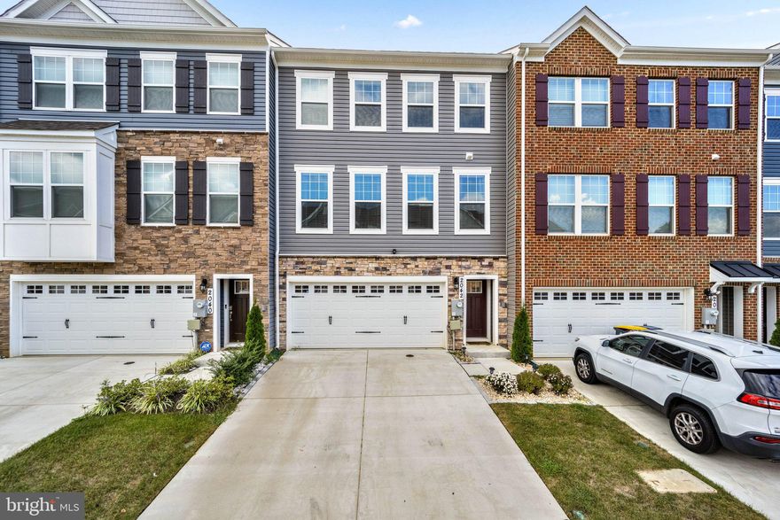 New $15,000 price adjustment.   Seller is offering a $5000 closing credit, $1000 agent bonus, and one year of HOA dues will be paid.  Home is now vacant.   Photos were taken during the fall of 2022 when the property was owner occupied..   Practically brand new three-level spacious townhouse located in the Woodmore Overlook community.  Home built by DR Horton in 2021 and is the largest model with over 2400 sqft of living and entertain space.   Great opportunity to get in this community since there are no more available homesites for sale.  Home features an open living concept on the main level with stainless steel appliances, 5 burner gas range, quartz countertops. large center island,  luxury vinyl floors, modern electric fireplace and a half bath.  A large deck sits off the kitchen.  The upper level has a spacious owner's suite with a large closet,  electric fireplace, and luxury bath with double sinks and shower.   The upper level also features two additional bedrooms, second  bath, and laundry room.  The finished lower level has a spacious room that can function as the fourth bedroom or recreation room.  This room features a full bath and closet.  Development is in walking distance to the Woodmore Town Center that has Wegmans, Best Buy, Costco, Copper Canyon, Nordstrom Rack and other restaurants and retail.