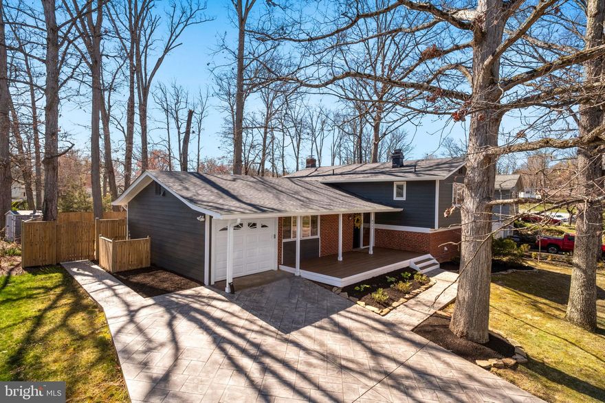 Truly spectacular property in highly desirable Riverside Estates. No expense was spared in totally remodeling and updating this special property. As you approach this home, the first feature to greet you is the expansive and welcoming front porch with "Trex" decking. The home's interior features an open concept enhanced by high ceilings and a 16ft glass wall of top quality thermal glass and "Pella" windows installed in 2022. Other features include custom kitchen designed to compliment the open  floorplan including gas cooking, island with overhand for seating, desk area, pantry cabinets, and custom lighting. Other features include: gorgeous hardwood floors on main and upper level, custom lighting throughout, 4 bedrooms on upper level, 3 renovated full baths, finished walk out lower level featuring rec room with fireplace, bedroom, sliding glass door at grade to patio, and laundry room. Low maintenance exterior features Hardi-plank siding, vinyl trim, and "Trex" decking. The back yard is enhanced by professional landscaping, privacy fence, and storage shed. More than ample parking provided by garage and stamped concrete driveway. Major updates include: roof (2024), decking (front 2023/back 2022), Fence by "Long Fence" (2022), Stamped concrete driveway and walk (2022), "LG" washer/dryer (2022), "Pella" windows (2022), "Hardi" siding (2022), remote controlled blinds on main level (2022), darkening shades in upper level (2022). If you're looking for a home in true "move in" condition, look no further. This is the one!