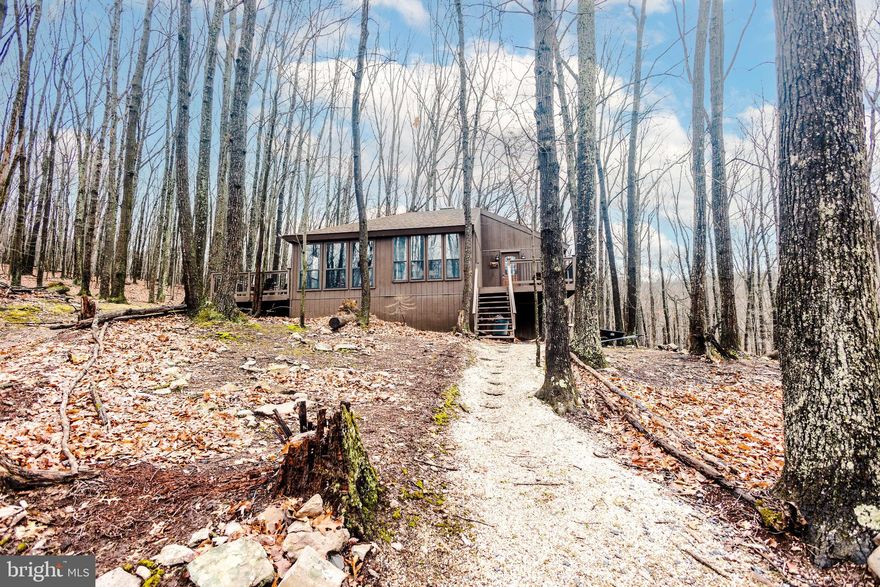 Furnished home in The Woods features 2 bedrooms, 1 bathroom, kitchen, living room, dining room, sun room, large porch/deck and yard.  Amenities package of $210/month will be responsibility of tenant.