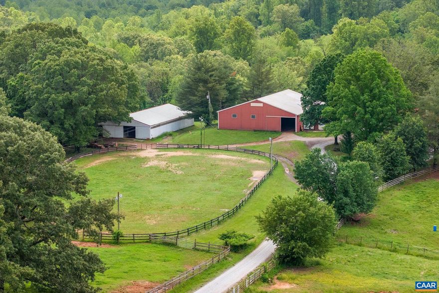 A Rare Equestrian Property on 47 Scenic Acres. This exceptional and well-established equestrian facility offers a unique opportunity for both personal enjoyment and business potential. The property includes a charming 2BR/3BA farmhouse and a separate 1BR/1BA barn apartment ?perfect for trainers, or staff.  Barn 1 is a commercial-grade structure featuring a durable metal exterior, concrete block interior walls, 17 stalls, a wide center aisle, 2 tack rooms, a wash stall, feed room, hay loft, office, and bathroom. A second barn offers 13 stalls, a wide center aisle, tack room, ample storage, and workshop space. Equestrians will appreciate the attached indoor arena, the lighted outdoor arena, additional flat riding area and abundant pastureland. This turnkey facility is ideal for training, boarding, events, or private use?all set amidst rolling, picturesque countryside. At the heart of the property is a welcoming and easy-to-manage farmhouse that blends functionality with comfort. With two large ensuite bedrooms and a total of three full baths, this home offers flexible living space for family or guests. The property is a blend of practicality and natural beauty. Two creeks run through the land, adding to the charm.