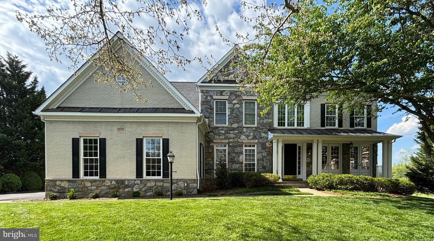 Welcome to this stunning Winchester Homes residence in the community of Stonebrook Village. Set at the end of a cul-de-sac, this home combines elegance, functionality, and an enviable location in Western Loudoun County. With 5 spacious bedrooms, 4.5 bathrooms, a 3-car side-load garage, and a finished lower level designed for entertainment, this property offers the perfect balance of luxury and comfort for today’s lifestyle.

From the moment you arrive, the exterior commands attention with its brick and stone façade and welcoming presence at the end of a cul-de-sac. The 1.4-acre lot is one of the largest in the neighborhood and provides a true sense of privacy and retreat. The expansive backyard opens to breathtaking views of mountains and farmland, offering a rare combination of community living with a rural backdrop.

Inside, the home welcomes you with a gracious two-story foyer, gleaming hardwood floors, and abundant natural light streaming through oversized windows. The main level features a thoughtful floor plan that seamlessly blends open-concept gathering spaces. The formal living and dining rooms are ideal for entertaining, while the private study offers a place to work from home. French doors off the living room lead to the front porch, providing both architectural charm and an inviting indoor-outdoor connection.

At the heart of the home, the gourmet kitchen boasts stainless steel appliances, granite countertops, a large island with seating, and ample cabinetry. Adjacent to the kitchen, the breakfast area and family room—with a cozy fireplace—invite relaxed everyday living.

Upstairs, the primary suite is a private sanctuary with tray ceilings, a spacious sitting area, and spa-like bath featuring dual vanities, a soaking tub, and separate shower. Three additional bedrooms on the upper level provide plenty of space for guests, along with the flexibility to create a second home office or hobby room. All bedrooms have been updated with new carpeting.

The finished lower level is a true highlight, offering endless possibilities for recreation and entertainment. Here you’ll find the fifth bedroom and a full bath, perfect for guests. Enjoy movie nights or big game days in front of the oversized screen, set up a home gym or hobby space, or create a playroom to suit your needs. With its open layout and direct access to the backyard, the lower level is an extension of the home’s living space. This area has also been updated with new carpeting.

Outdoor living is equally impressive. The expansive deck provides panoramic views of the rolling countryside and farmland beyond. With over an acre of open space, the backyard offers room to garden, play, or simply relax while soaking in the peaceful mountain vistas. A lower paved patio off the walkout basement door provides additional space for entertaining.

Location is another key advantage. Just 15 minutes from the historic town of Leesburg, the property offers easy access to shopping, dining, and entertainment, as well as commuter routes to Washington, D.C., and Northern Virginia employment centers. For those who love to explore, Western Loudoun is renowned for its wineries, breweries, and farm-to-table experiences.

This home truly combines the best of both worlds: the space, privacy, and scenery of country living with the convenience of being close to town. Don’t miss the opportunity to make this exceptional home your own.