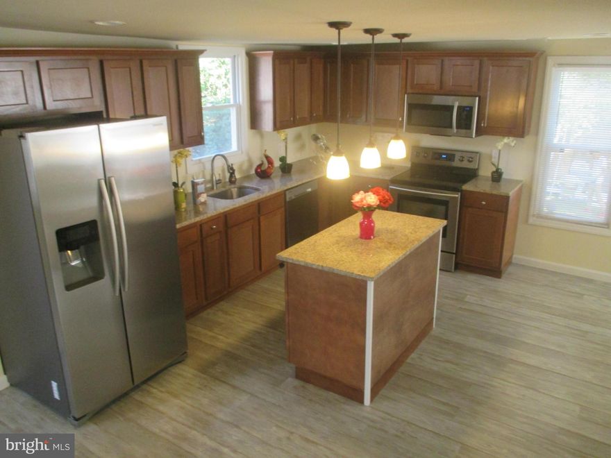 100% Renovated. Everything Brand New.Stainless Steal, Kitchen ISLAND,Morning Rm, 3 Levels, 5 bedrooms, 3.5 bathrooms, Brazilian floors, new carpet, central ac & heat, House comes with Washer/Dryer at closing. Main Level in law suite with bathroom, Open Floor Plan, MD St offering to pay $5,000 for your down payment, we will pay $7,000 for closing costs.  Driveway, backyard, WRAP around front porch.