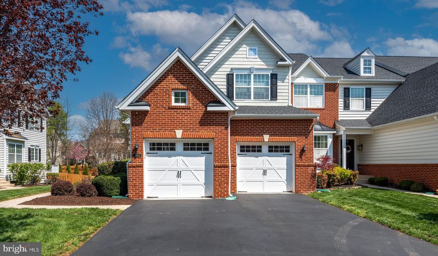 Best Value in the Coveted Dominion Valley Country Club! Perfectly maintained by its original owner, this end-unit townhome with a 2-car garage lives like a single-family retreat. Boasting approximately 3,200 sq ft across three beautifully finished levels, this 3-bedroom, 3.5-bath home offers comfort, space, and style. Step into an open-concept floor plan featuring stunning maple wood floors throughout the main level. The formal living room impresses with a two-story vaulted ceiling and skylight, while the separate dining room showcases elegant crown molding. The spacious kitchen is flooded with natural light through a Palladian window and includes granite countertops, stainless steel appliances, and a cozy breakfast nook. Step outside onto the maintenance-free deck—perfect for morning coffee or evening relaxation. Upstairs, the large owner’s suite features a cathedral ceiling, walk-in closet, and a luxurious en-suite bath with upgraded ceramic tile, a soaking tub, and separate shower. The finished basement includes a full bath, a generous rec room with egress window, and tons of storage space—ideal for entertaining or relaxing. Additional features include: Upgraded light fixtures throughout, Premium lot backing to trees for added privacy, Roof replaced in 2017, Water heater replaced in 2020, Abundant guest parking. Great location: a short walk to Gravely Elementary and the Waverly Club (featuring both indoor and outdoor pools). Enjoy world-class community amenities including the Arnold Palmer Signature Golf Course, a renovated clubhouse, state-of-the-art Sports Pavilion, five pools, tennis and basketball courts, playgrounds, miles of walking/biking trails, and two scenic fishing ponds. Award winning schools!