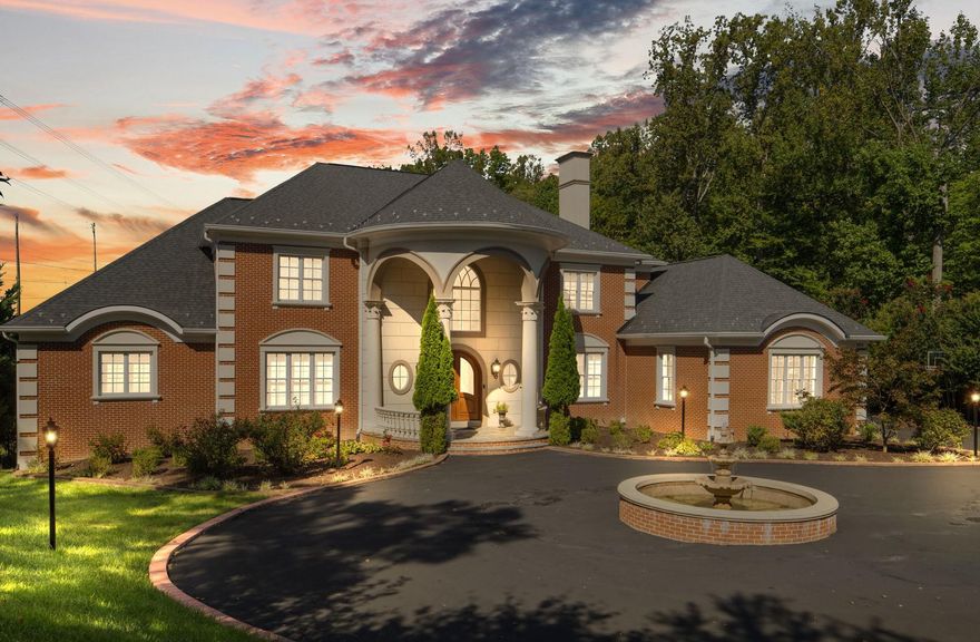 A Masterpiece of Design: Welcome to 9889 Oxcrest Dr., an unparalleled custom-built by Botero Homes, an award-winning luxury home builder. This All-brick Colonial residence nestled on 5-acre lot in the prestigious OX HUNT ESTATES of Fairfax Station. Completed in 2014, this home was crafted with meticulous attention to detail, creating a sanctuary where luxury meets comfort.

Approach via the private, column-flanked entrance and elegant circular driveway, anchored by a center water fountain. Exterior lighting illuminates the property, enhancing its timeless charm as twilight falls. The covered two-story portico leads to a grand arched double front entry door and Foyer.

Inside, an expansive grand two-story foyer introduces a bright, open-concept layout defined by soaring ceilings, expansive rooms, and oversized windows that bathe the over 8,500 square feet of living space in natural light. This exceptional 5-bedroom, 5.5-bath residence features a unique and highly desirable amenity: two distinct Primary Suites, one on the main level for ease and flexibility, and a second on the upper level. Every bedroom boasts its own private full bathroom suite.

The professional-grade gourmet kitchen is a chef's dream, showcasing a spacious center island, classic white cabinetry, elegant granite counters, and stainless-steel appliances. The space flows seamlessly into a breakfast room, a butler's pantry, and a separate, fully equipped catering kitchen (range/oven, microwave, dishwasher, sink, and full refrigerator) perfect for entertaining. Relaxation awaits in the centrally located family room, featuring a two-story coffered ceiling and a magnificent gas fireplace with glass doors, radiating warmth and sophistication.

The Entertainer's Paradise, the walkout lower level, spanning over 2,200 square feet, is built for lavish entertaining. It hosts a full bar, a home theater, a card room area, two large recreation spaces, an exercise room, and the fifth bedroom and full bathroom. Full-size windows throughout ensure abundant natural light. Modern security features, including an alarm and a water leak detection alarm system with automatic water shut off and exterior cameras, provide complete peace of mind. 

Unbeatable Location: Enjoy an exclusive lifestyle just moments from nature and convenience. This prime location is near Burke Lake, Sandy Run Stream Valley Park, and Fountainhead Park, offering endless opportunities for hiking, mountain biking, and equestrian trails all near-by. Access the Occoquan Reservoir for boating and kayaking or visit the charm of the Occoquan Historic District and quick access to I-95 is all within 5 miles.