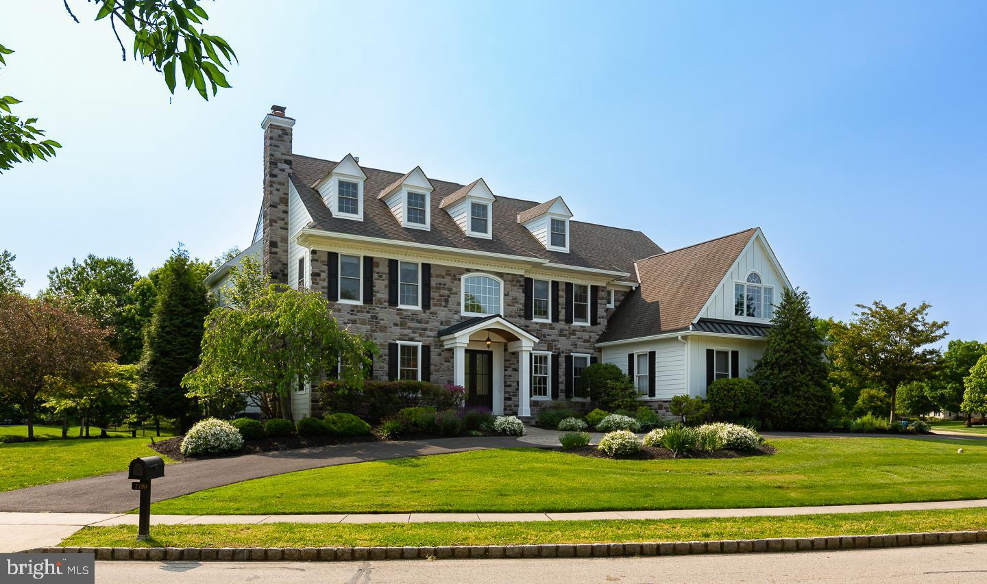 This magnificent custom built stone-front home with over 7000 Square Feet captivates all with remote privacy and impeccable custom details throughout. Located in the prestigious and desirable neighborhood of Springhouse Farm, this 6 bedroom, 4.2-bathroom luxurious home has everything you need to live happily ever after! As you drive up the circular driveway to the grand main entrance, you are surrounded by beautifully maintained hedges and vibrant foliage in the lush front gardens. Entering the home through the double french doors with large glass panes, you are greeted by a vast two-story center hall foyer detailed with glistening hardwood flooring and tasteful crown molding. Directly off the foyer to your left sits an elegant living room adorned with a marble surround gas burning fireplace, plush carpeting, and crown molding. The living room leads you to the glass French doors of the private home office in the rear of the home that sits adjacent to an elegant powder room. Make your way back to the foyer and cross the center hall to formal dining room that has hardwood flooring and plenty of crown molding. Nestled in the back of the home sits your gourmet eat-in kitchen featuring sleek granite countertops, commercial-grade stainless steel appliances, a plethora of wooden cabinetry, a large center granite-topped island with barstool seating, masterfully finished tiled flooring and backsplash, and a butler’s pantry. Artistic tiling leads you to the breakfast room offering captivating views of the backyard and providing you with direct access to the substantial multi-leveled flagstone back patio. Open to the kitchen and breakfast area, the magnificent great room is decorated with a vaulted ceiling, marble-surround wood-burning fireplace, custom built-in shelving, and extra-large windows. Rounding out the first floor is connected three-car garage access, tiled mudroom, another powder room and a practical back stairway with second-floor access. Take the staircase of your choice up to the second floor and find your way to the primary suite masterfully detailed with an intimate sitting area, dual walk-in closets, and recessed lighting. The exclusive ensuite bath is equipped with two stand-alone vanities, a soaking tub, and a glass-enclosed tiled shower. Four additional bedrooms can be found on this floor each with lush carpeting and ample closet space. All four bedrooms share a jack-and-jill bathroom. This floor is complete with a quaint reading nook and a laundry room providing cabinet storage space and a convenient sink. Head up to the third level of this home to find a sixth bedroom however boasts plenty of square footage to accommodate a second office or playroom. The substantial lower level has everything you are looking for to host your next gathering of family and friends. The space includes an expansive wet bar with barstool seating and a sink, an immense living area, a fun-filled game room, a private in-home fitness studio, a full bathroom, and an immense amount of storage opportunities. Exit the home through the glass exterior door in the breakfast room to the comprehensive tree-lined rear yard, equipped with a custom paver patio perfect for entertaining with a built-in outdoor kitchen area, yards of rolling green grass, and pristine gardening beds. Invisible fence, Sonos wired throughout the house and outside on the patio, sprinkler system outside plus so many other upgrades included! Located in the award winning Wissahickon school district, this home is also within a few miles of countless golf courses, trails, restaurants and major shopping. Conveniently located near major highways and public transportation which makes commuting a breeze.