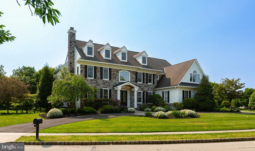 This magnificent custom built stone-front home with over 7000 Square Feet captivates all with remote privacy and impeccable custom details throughout. Located in the prestigious and desirable neighborhood of Springhouse Farm, this 6 bedroom, 4.2-bathroom luxurious home has everything you need to live happily ever after! As you drive up the circular driveway to the grand main entrance, you are surrounded by beautifully maintained hedges and vibrant foliage in the lush front gardens. Entering the home through the double french doors with large glass panes, you are greeted by a vast two-story center hall foyer detailed with glistening hardwood flooring and tasteful crown molding. Directly off the foyer to your left sits an elegant living room adorned with a marble surround gas burning fireplace, plush carpeting, and crown molding. The living room leads you to the glass French doors of the private home office in the rear of the home that sits adjacent to an elegant powder room.  Make your way back to the foyer and cross the center hall to formal dining room that has hardwood flooring and plenty of crown molding.  Nestled in the back of the home sits your gourmet eat-in kitchen featuring sleek granite countertops, commercial-grade stainless steel appliances, a plethora of wooden cabinetry, a large center granite-topped island with barstool seating, masterfully finished tiled flooring and backsplash, and a butler’s pantry. Artistic tiling leads you to the breakfast room offering captivating views of the backyard and providing you with direct access to the substantial multi-leveled flagstone back patio. Open to the kitchen and breakfast area, the magnificent great room is decorated with a vaulted ceiling, marble-surround wood-burning fireplace, custom built-in shelving, and extra-large windows. Rounding out the first floor is connected three-car garage access, tiled mudroom,  another powder room and a practical back stairway with second-floor access. Take the staircase of your choice up to the second floor and find your way to the primary suite masterfully detailed with an intimate sitting area, dual walk-in closets, and recessed lighting. The exclusive ensuite bath is equipped with two stand-alone vanities, a soaking tub, and a glass-enclosed tiled shower. Four additional bedrooms can be found on this floor each with lush carpeting and ample closet space. All four bedrooms share a jack-and-jill bathroom. This floor is complete with a quaint reading nook and a laundry room providing cabinet storage space and a convenient sink. Head up to the third level of this home to find a sixth bedroom however  boasts plenty of square footage to accommodate a second office or playroom. The substantial lower level has everything you are looking for to host your next gathering of family and friends. The space includes an expansive wet bar with barstool seating and a sink, an immense living area, a fun-filled game room, a private in-home fitness studio, a full bathroom, and an immense amount of storage opportunities. Exit the home through the glass exterior door in the breakfast room to the comprehensive tree-lined rear yard, equipped with a custom paver patio perfect for entertaining with a built-in outdoor kitchen area, yards of rolling green grass, and pristine gardening beds. Invisible fence, Sonos wired throughout the house and outside on the patio, sprinkler system outside plus so many other upgrades included!  Located in the award winning Wissahickon school district,  this home is also within a few miles of countless golf courses, trails, restaurants and major shopping. Conveniently located near major highways and public transportation which makes commuting a breeze.