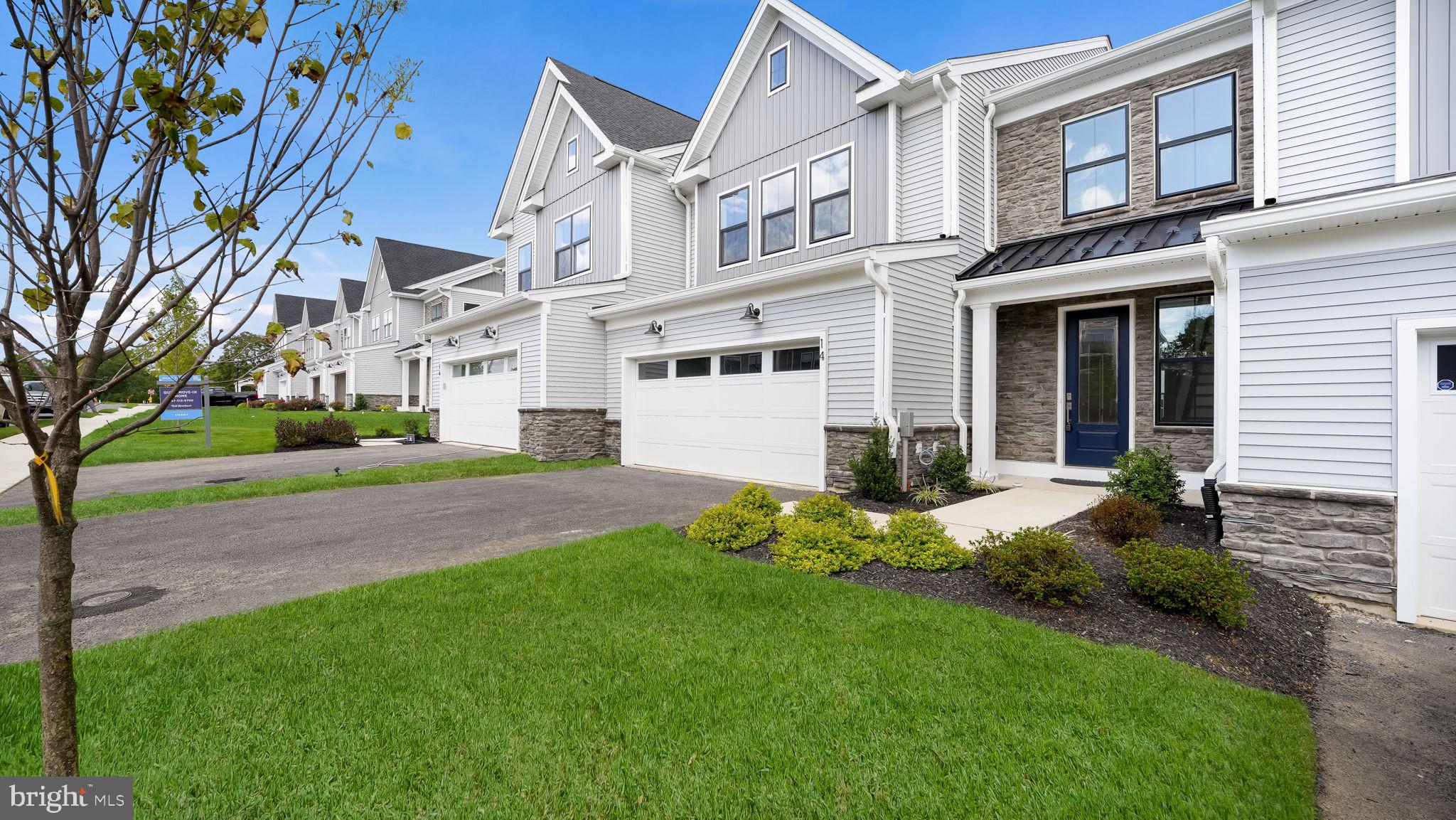 AVAILABLE FOR IMMEDIATE DELIVERY!! Welcome to 14 Mill Creek Drive, where luxury living meets convenience in the coveted Doylestown Walk community. This brand new, NEVER OCCUPIED Redfield floor plan boasts 3 bedrooms, including a Primary Suite on the MAIN living level, 2.5 baths, and a 2-car garage, all crafted with meticulous attention to detail. This home offers modern comfort and timeless elegance. As you enter, you're greeted by a grand 2-story foyer adorned with hardwood floors, setting the stage for the elegant interiors. The open-concept layout is perfectly suited for contemporary living, with the voluminous great room serving as the focal point. Floor-to-ceiling windows flood the space with natural light, while a gas fireplace and exquisite trim detail create a warm and inviting ambiance. The upgraded kitchen is a chef's delight, featuring stainless steel appliances, a large center island with storage below, stacked cabinets to the ceiling, quartz countertops, a 6-burner cooktop, refrigerator and an exposed hood vent. Abundant storage ensures a clutter-free space, while the adjacent laundry room offers convenience with a laundry sink and ceramic tile flooring. The primary bedroom suite is a serene retreat, boasting a spacious layout and a customized walk-in closet. The deluxe primary bath exudes luxury with dual sinks, tile accents, and a frameless glass shower. Upstairs, a loft area overlooks the great room, providing versatile space for a home office, secondary gathering area, or quiet retreat. Two additional bedrooms, one with a generous walk-in closet, and a full bath complete the upper level. Step outside to the custom paver patio, perfect for enjoying your morning coffee or hosting your next barbeque. Close to major traffic routes and downtown Doylestown Borough, offering an array of dining, shopping, and entertainment options. Don't miss your opportunity to experience luxury living at its finest. Schedule a showing today and make 14 Mill Creek Drive your new home sweet home. GET ONE OF THE FINAL REMAINING HOMES IN DOYLESTOWN WALK!!