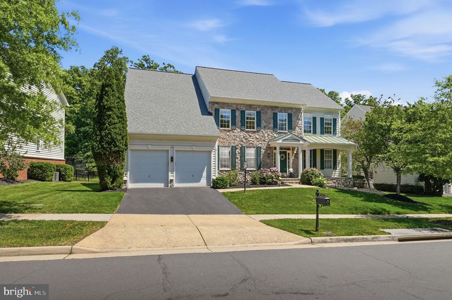 GORGEOUS HOME IN LANSDOWNE ON THE POTOMAC! Beautifully maintained single-family home with over 5300 square feet of modern living space offering 4-finished levels including a loft and a private fenced backyard backing to trees! This gracious home features welcoming curb appeal with a stone and vinyl siding elevation.

Step inside to a dramatic two-story foyer with iron balusters on the oak staircase and hardwood floors throughout the main and upper levels. The main level offers formal living and dining rooms, a private office with built-ins, powder room, and a family room with elegant, coffered ceilings and gas fireplace. The gourmet kitchen opens seamlessly to the family room and features cherry cabinetry, granite countertops, tile backsplash, center island, pantry, and a bright breakfast area overlooking the backyard. Black appliances include a 5-burner gas cooktop and double wall ovens.

Upstairs, the spacious primary suite includes a sitting room, coffered ceilings, and a private bath with dual vanities, soaking tub, and separate shower. Three additional well-sized bedrooms include one with an en-suite bath and two sharing a bath. The upper loft level adds a bedroom, full bath, and flexible space ideal for guests, office, or recreation.

Rest and relax in the fully finished walk up lower level featuring a large recreation room with laminate flooring, bonus room, full bath, storage, and a washer and dryer (2023). Enjoy the fully fenced backyard with patio, ambient lighting, irrigation system, and peaceful views...perfect for barbecues, entertaining or stargazing. Additional highlights include a two-car front-load garage, mud room with washer/dryer hookups, fresh paint, roof (2024), two HVAC systems (upper 2019), sump pump with battery backup, security system, and irrigation system.

Live your best life in Lansdowne! Residents enjoy resort-style amenities in the highly sought-after community including indoor and outdoor pools, fitness center, sport courts, playgrounds, trails, and year-round community events. Ideally located minutes from downtown Leesburg, Reston Town Center, and Dulles International Airport, this home offers the perfect blend of luxury living, community, top-rated schools, and an exceptional location!
