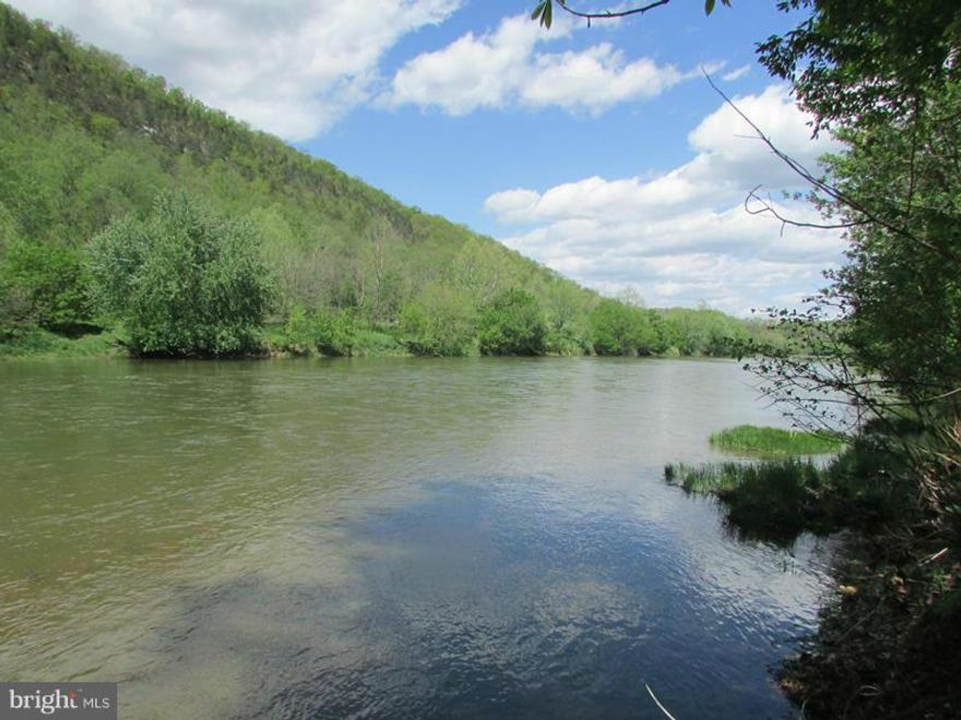 ROLL ON BIG RIVER! 20 AC WITH 1097 FT OF USEABLE FRONTAGE ON THE SOUTH BRANCH OF THE POTOMAC RIVER. 10 AC OF HIGH AND DRY FLAT WOODLAND WITH DRIVEWAY INSTALLED TO BUILD SITE OVERLOOKING RIVER, DRIVEWAY ALSO LEADS TO 10 AC OF RIVERBOTTOM MIX OF FIELDS & FOREST. SUPER COOL LAGOON/POND IN BOTTOM LOADED WITH FISH. HUNT,SHOOT,CAMP,BUILD,BOAT,FISH,ATV'S OR JUST RELAX. RARE OFFERING. 2 HOURS FROM DC/BALT