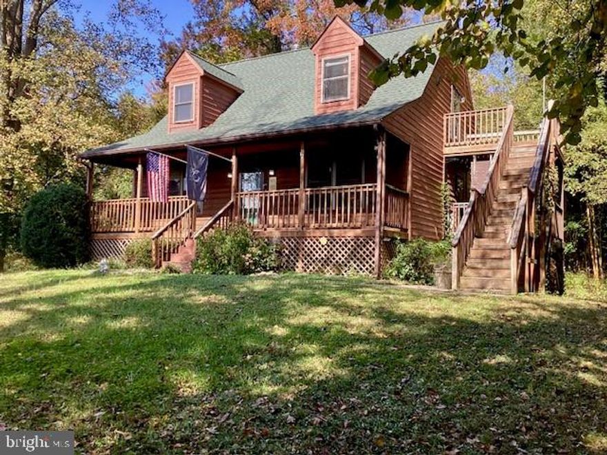 LOVELY CAPE COD ON 1.5 WOODED ACRES. THIS LOT IS VERY PRIVATE. THE LARGE FRONT PORCH IS PERFECT FOR YOUR ROCKING CHAIRS. MASTER BEDROOM ON MAIN FLOOR. THE FAMILY ROOM AND KITCHEN DINING AREA HAVE RE-ENGINEERED YELLOW PINE HARDWOOD FLOORING (additional flooring pieces in basement) A GRANITE KITCHEN ISLAND WITH DROP PENDANT LIGHTING AND FAIRLY NEW WHITE KITCHEN CABINETS AND APPLIANCES. TWO NEW STEEL KITCHEN SHELVING PIECES CONVEY.   SLIDER OFF KITCHEN HAS A BACK DECK OVERLOOKING WOODS, DOOR TO 2ND DECK OFF KITCHEN ON RIGHT SIDE OF HOUSE AND UPSTAIRS A 3RD TOP DECK OFF OF BEDROOM 3. FAIRLY NEW LONG ASPHALT DRIVEWAY WITH TURN AROUND AREA TO LARGE 1 CAR DE-TACHED GARAGE. FULL SIZE WALK OUT BASEMENT HAS A WORK BENCH AND SLIDER TO BACK YARD. THIS CHARMING CAPE COD IS LOOKING FOR NEW OWNERS TO BRING IT SOME TLC AND ENJOY ITS SERENE SETTING.