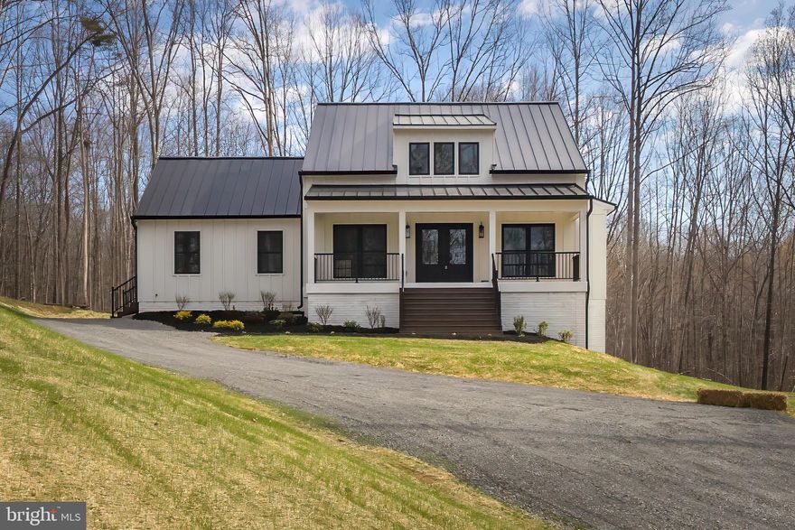 The Modern Farmhouse Reimagined and Thoroughly Refined!  Beautifully situated on 14+ acres, this 4 Bed/3 Bath Home is Nothing short of a masterpiece ... You'll realize something is truly different the moment you drive up.  From the board and batten siding to the standing seam metal roof. The moment you open the front door, you'll be in awe of the soaring ceilings and refined spaces.  Luxury vinyl plank throughout most of the house and beautiful tile in all the bathrooms and mud room.  The gourmet kitchen is incredible with its upgraded countertops and finishes ... don't overlook the high-end Kitchen Aid appliance package or walk-in pantry with sliding barn door.  Primary suite with massive vaulted ceiling and luxurious bath with custom tile walk-in shower.  Large dining room. Synthetic custom screened porch with grilling deck.  Finished lower level with oversized rec room, 2 additional bedrooms, fantastic bath and cozy office/study.  This home is simply not to be missed!!