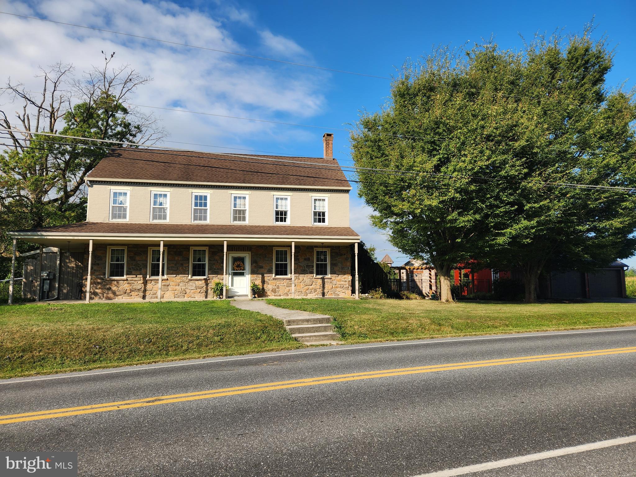 This property will be offered at Public Auction on Wednesday, October 15, 2025 @ 6pm. The listing price is the opening bid only and in no way reflects the final sale price. 10% down due at auction, 2% transfer tax to be paid by the purchaser, real estate taxes prorated. This picturesque 13.1-acre property features approximately 10 tillable acres, a beautiful two-story farmhouse, a 4-stall horse barn with electric, a spring house, and an oversized detached 2-car garage. Inside the farmhouse, the first floor offers a spacious living room with a stone propane fireplace, an open kitchen and dining area, a sun porch, a first-floor bedroom, a convenient powder room, and a versatile space that once served as the original kitchen. The second floor hosts a primary suite with an attached full bathroom and laundry, along with two additional bedrooms and a full bathroom. Additional amenities include an unfinished basement, a UV light water filtration system, an above-ground pool, and an outdoor deck—perfect for entertaining friends & family! The property is enrolled in Clean & Green but is not preserved. Don’t miss this one-of-a-kind opportunity in Rapho Township!