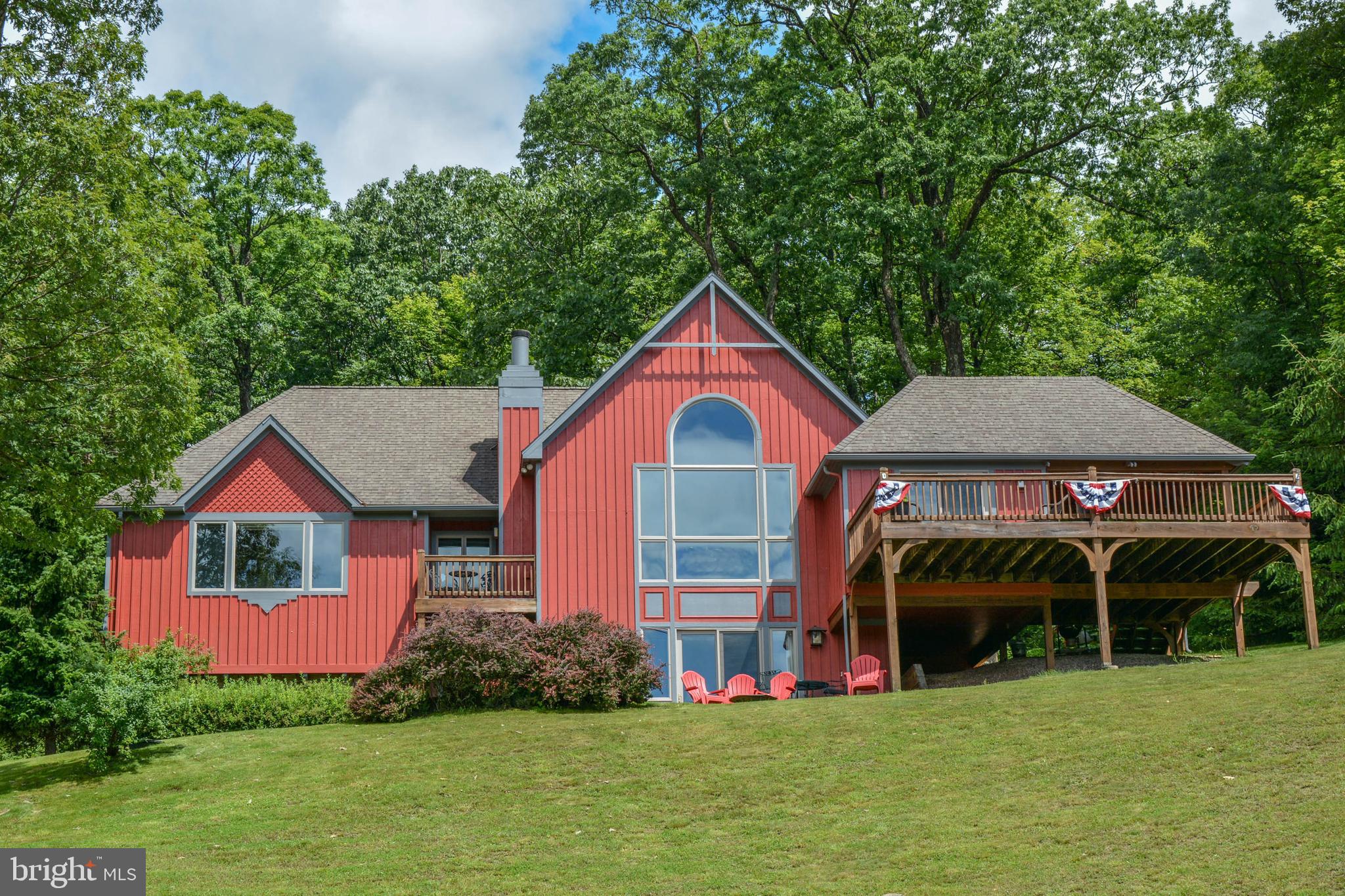 Hands down, one of the most spectacular views on the lake!!! You will be in awe as you take in the scene from this serene perch overlooking Deep Creek Lake, MD. This 5 bedroom craftsman-style masterpiece will grab your heartstrings as soon as you enter. Gorgeous wood floors, updated kitchen, new floors, extensive hardscaping, 2 car attached garage, dedicated boat slip, custom tasteful interior decor, main floor primary bedroom, and the list goes on. If you're going to be at the lake, you want to experience it from this vantage point. Truly unique. Very Strong Vacation Rental History. Seller is also offering a home warranty at settlement.