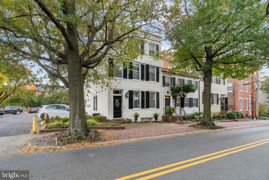 Beautifully restored and uniquely designed, this 1845 historic residence in the heart of Old Town, offers the most discriminating buyer a special opportunity to own a treasure in this most sought-after community.  This all-brick residence has been meticulously maintained, and the windows, shutters and doors are in excellent condition.  Over two dozen windows are carefully placed to provide privacy and wonderful exposure, in addition to side, front and back yard entrances.  Each further reflects the captivating charm of this colonial home.
On the main level there is a hallway that is naturally well lit (and end unit and a transom above the entry door) and lovely living room with original windows and a hallway with 2 large windows  Multiple windows in the dining room and first floor family room are complemented by period fixtures, original floors, door, window and fireplace moldings and chair rails.    All the custom shutters throughout the home convey as do the 3 mounted tv's.  
Four fireplaces have been consistently maintained, cleaned and serviced
 and certified to be in working order.  The updated ADT system remains and the next owner may wish to take over the current contract.  The outdoor shutters and many of the interior shades have been replaced or repaired in recent years.  Existing storm windows and screen convey.
A welcoming living room with fireplace, good sized separate and nicely detailed dining room, coat closet, a half bath, a laundry closet with stacked washer and dryer, a separate family room with fireplace with custom built-in bench for storage and seating and a chef's kitchen with Viking Stove, microwave, side-by-side Jenn-Air refrigerator, good counter space and cupboard storage are  showcased by beautiful windows, glass-paned doors and side and back entrances with period flooring are the outstanding features of the first level.
North, South, East and Western exposures in this home are exceptional!
The upper two floors are approached by a dramatic staircase with original flooring and staircase details, and bright eastern exposure through period windows.
Several bedroom arrangements with sitting areas or at-home office space make each of the 3 bedrooms more than a simple room.  The bathrooms have had extensively renovated (fixtures and floors) over the years.  These rooms have custom built-ins and adequate closet space for a residence of this vintage.  Period hardware, solid wood doors and old-world charm abound!!
The backyard is a special place for many reasons:  its fully enclosed brick wall with an entrance to the parking area and the side are most convenient.  Parking can be arranged through St. Mary's in their adjacent parking lot just steps from your backyard.
The magnificent magnolia tree in the back yard is simply astonishing in its beauty and health (recently evaluated by a local arborist) and a custom easy to maintain garden with seasonal plantings and special lighting create a natural place of beauty that is simply gorgeous!  The propane heater will convey for enjoying this "little paradise" on cooler evenings!  A customized, handsome built-in storage area with separate doors solves any outside storage needs.  An inner courtyard boasts of beautiful flowering bushes.  There are generous storage areas in two outside easily accessible basements which are heated and have remained dry throughout this owner's occupancy.  A new roof  and HVAC system are being installed!!
Located just 2 blocks from King Street and 3 from the Potomac River, this historically designated  home is ideally located in a residential area that affords privacy but also easy access to cultural activities, excellent shopping, fine restaurants, historically significant buildings, museums,  and a real taste of what this historic seaport exudes as a unique living experience.
For condition, location, price and charm, this is a wonderful buying opportunity!  We thank you for visiting and welcome your further inquiries.