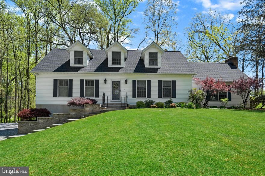 This amazing home in Marriottsville gives you all the luxury and privacy one could ever hope for. Nestled on over three acres in Howard County, surrounded by lush landscaping, this home is waiting for you to call it your very own. The foyer is full of natural light, featuring the staircase leading to the upper floor. Gorgeous vaulted ceilings dress the spacious living area complete with a stunning wood burning fireplace as a vocal point. Prepare, cook and serve a meal in the enormous country kitchen, stacked with gleaming hardwood floors, high end stainless steel appliances, granite countertops, large double farm sink, island, custom tile backsplash with a unique mosaic above the stove and storage galore! Skylights and oversized windows embellish a large roomy sitting room, ideal for an office or additional living area. Take a step out onto the dreamy screened in porch, detailed with skylights and jetted hot tub perfect for entertaining, stargazing, and listening to all the frogs, birds and nature that surrounds you. Rest and retreat in the immaculate primary suite, complete with large walk-in closet and ensuite bathroom decorated with modern fixtures, custom tile work, dual shower head and other spa like features. The additional bedrooms are spacious, ideal for family and friends to rest well. The lower level is open and airy ideal for a recreation area complimented with a full bath. The yard space is dreamy and superb for BBQs, gatherings and endless summer fun. A large driveway provides ample parking leading to the attached two car garage. The HVAC, water heater and roof are all NEW! What are you waiting for, schedule your showing and take your first look at your dream home!
