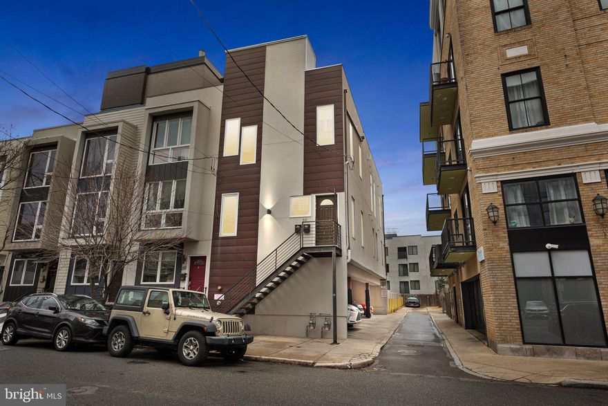 Welcome to 211 Green Street! This stunning 2 bedroom, 2 full bathroom second floor corner condo is in the heart of Northern Liberties with a private rooftop deck. This modern home features soaring 11-foot ceilings, an open floor plan, hardwood flooring throughout, and oversized windows, filling the space with natural light. The Chef's Kitchen boasts granite countertops, subway tiled backslash, shaker style walnut cabinets, stainless steel appliances, and a spacious island, perfect for entertaining. The primary bedroom features ample closet space and  an en-suite with  a subway tiled stall shower, while the second bedroom is ideal for guests or a home office. There is a second full bathroom with subway tiled stall shower as well. Walk up a staircase with access to a a private approximately 58'x18' rooftop deck perfect for hosting those summer nights. Also enjoy the convenience of in-unit laundry, recessed lighting, smart home features, and a private covered parking spot. Located just steps from trendy restaurants, cafes, shops, and public transit, this home offers the best of city living. Don’t miss out on this Northern Liberties gem!