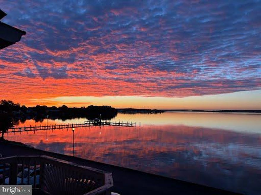 Discover a rare gem in Essex offering unmatched water views rarely found anywhere in the city. This stunning water view townhome features three fully finished levels and an affordable HOA, blending lifestyle and value seamlessly. Thoughtfully upgraded throughout, the home showcases wall-to-wall closets with stylish barn doors, creating both function and character. Both full baths are beautifully appointed with rain showerheads, adding a spa-like touch to everyday living. Enjoy the low/no maintenance front and rear yards. Just a quick sweep (not mow), then let the entertaining begin.  Private parking is tucked away on a no-through street, offering peace and convenience. The community completes the experience with direct access to a pier and boat slip, making waterfront living effortless. From sunrise reflections to evening breezes, this home delivers a truly special setting designed for comfort, connection, and exceptional coastal living. Photos for this listing have been virtually staged.