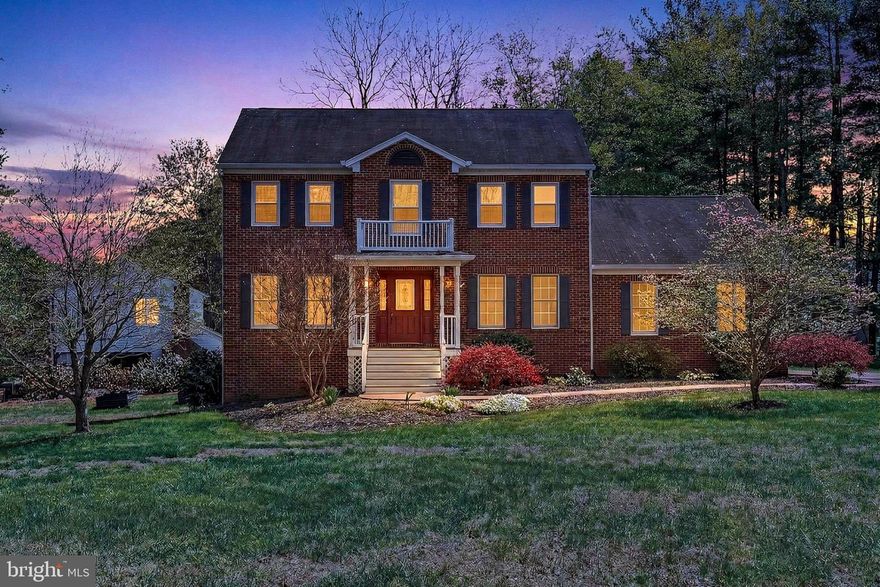 ** OPEN HOUSE WEEKEND - Saturday, 5/2 from 12-2 PM + Sunday, 5/3 from 1-4 PM **CHARMING COLONIAL ** Set on just over 1.5 acres in the Auburn Crossing neighborhood of Catlett, Virginia, this stately Colonial offers a refined blend of craftsmanship, comfort, and wooded tranquility in a sought-after setting. The home features 4 bedrooms and 2.5 baths, highlighted by a tailored exterior, a Georgian-style front entrance, a two-car side-loading garage and a multi-area deck overlooking a vibrant lawn. Inside, rich hardwood floors, decorative moldings, designer paint, recessed lighting, a fireplace, and a thoughtfully designed gourmet kitchen contribute to a residence that balances elegance with everyday livability. Expansive windows invite natural light throughout, while well-defined spaces create a harmonious flow for both daily living and entertaining.

Warm hardwood flooring greets you in the foyer and continues into the formal dining room, where generous proportions accommodate large gatherings and an oil-rubbed statement chandelier provides a refined focal point. The formal living room offers an inviting space filled with natural light, ideal for welcoming guests or enjoying quiet conversation, and features refined detailing that complements the home’s classic style. The country kitchen impresses with handcrafted cabinetry, a designer backsplash, and high-end stainless steel appliances, including a dual-oven range. The adjoining breakfast area offers a comfortable space for casual dining and features a built-in planning center desk along with a glass door that opens to a wraparound deck overlooking a rolling lawn, a playset, a gardener’s shed, and mature trees, creating a seamless connection between indoor and outdoor living. The sunken family room provides a welcoming retreat centered around a cozy fireplace and flows into a stunning sunroom addition featuring marble tile flooring, a soaring cathedral ceiling, and French doors that lead to the deck. A dedicated den offers an ideal setting for a home office, while a powder room and a well-equipped laundry center enhance functionality on the main level.

Upstairs, the primary suite offers space for a sitting area, a walk-in closet, and an en suite bath with a dual-sink vanity with granite top, a glass-enclosed tub and shower, and spa-inspired tile finishes designed for relaxation. Three additional bedrooms, each bright and inviting with ceiling fans and generous closet space, share a beautifully appointed hall bath featuring a dual-sink vanity. The walkout lower level features a spacious recreation room with built-in storage, providing flexibility for games, media, or exercise. A utility area and additional storage solutions further enhance the home’s practicality. Updates include: New windows on upper level (2025), Refrigerator (2024), HVAC (2018).

This private retreat offers a peaceful atmosphere while maintaining convenient access to Routes 28 and 234, the Prince William Parkway, and the VRE. Nearby Manassas and Gainesville present a wide array of shopping and dining options, while outdoor destinations such as Prince William Forest Park provide opportunities to explore thousands of acres of natural beauty. Designed with enduring quality and timeless appeal, this exceptional property presents a lifestyle of comfort, space, and quiet sophistication. Welcome home!