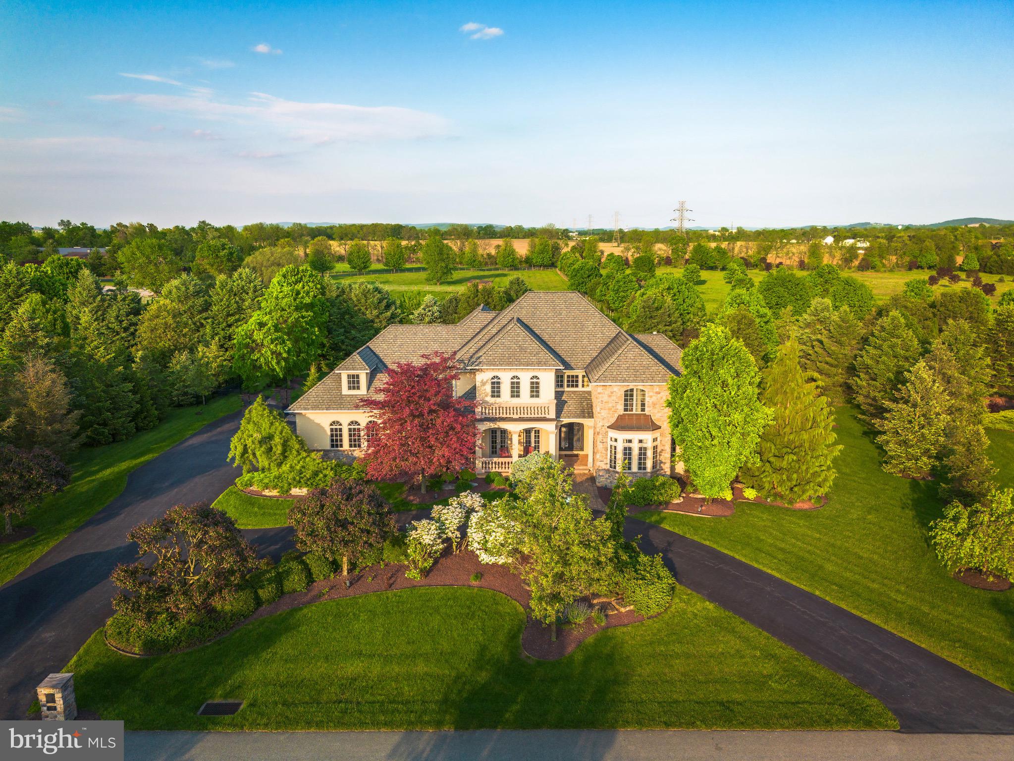 Get ready to be impressed, your Search Ends Here! Pride of Ownership is evident in this Custom Built 5 Bedroom, 5.5 Bath Colonial situated on a Premium Lot in the Exclusive Stonebriar Neighborhood of Desirable Bethlehem, Pennsylvania. Mature Landscaping and Premium Property Placement create a sanctuary of peace & privacy all year-round! Beautiful stucco & stone accented exterior, impressive circular driveway, and inviting Front Porch set the stage for quality - upon entering the Grand Foyer, you're welcomed with tasteful neutral paint and stunning travertine tile floors flowing throughout the majority of the First Floor. Open Floor Plan greets you and leads you right into the Formal Dining Room with elegant chandelier - Perfect for Entertaining Family and Friends. Two-Story Family Room boasts coffered ceiling, beautiful stone fireplace with mantle and large hearth and is overlooked by the breath-taking Eat-In Kitchen, enjoy top of the line stainless steel appliances, custom cabinetry, tile backsplash w/pot filler over the stove, custom leather granite countertops, large walk-in pantry, and enormous center island with barstool overhang and additional storage. Kitchen area also includes large Sun-Soaked Breakfast Room overlooking the serene Backyard Oasis. Down the Hall, Large Executive Office with glass doors and custom built-ins creates the perfect space to Work From Home! First Floor Grand Master Bedroom Suite includes Sitting Area, Impressive Walk-In Closet, Private Updated Ensuite Master Bathroom. Master Bathroom is sure to impress with two separate vanities, stall shower, soaking tub, and linen closet. Also on the 1st Floor you'll find the Half Bathroom & the convenient 1st Floor Laundry Room. Upstairs, 4 generously sized Bedrooms and 3 Additional High-End Full Bathrooms make up the rest of the 2nd Floor! Great for large families or those who love to host! 2nd Floor also boasts a large loft area that can be used as another space to work from home and a 2nd Laundry Room for ultimate convenience. No detail has been missed! Downstairs, the Fully Finished Basement features recessed lighting, built in bar area, and an additional 5th Full Bathroom with stall shower. So much room to grow and create an additional family room, home gym, guest suite, etc - the possibilities are endless! The Basement also includes plenty of additional storage space and walk-out entrance to the Garage. Outside, the Huge Backyard is Fully Fenced and boasts beautiful In-Ground Gunite Saltwater Pool with stone accented waterfall feature and connected hot tub with additional waterfall feature. Other backyard features include extensive patio area, mature landscaping with gazebo and built in outdoor kitchen area with granite countertops, barstool seating, built in beverage fridge, and built in grill. The ultimate luxury experience! Perfect for those who love their vehicles - oversized 3 Car Garage with room for Additional Storage. With Custom Finishes from Top to Bottom, this home is sure to please and have room for everyone to enjoy! Great Location. Close to Major Highways, Public Transportation, Shopping, Restaurants, Highly Rated Golf Courses, Parks & Schools!