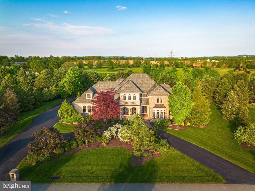 Get ready to be impressed, your Search Ends Here! Pride of Ownership is evident in this Custom Built 5 Bedroom, 5.5 Bath Colonial situated on a Premium Lot in the Exclusive Stonebriar Neighborhood of Desirable Bethlehem, Pennsylvania. Mature Landscaping and Premium Property Placement create a sanctuary of peace & privacy all year-round! Beautiful stucco & stone accented exterior, impressive circular driveway, and inviting Front Porch set the stage for quality - upon entering the Grand Foyer, you're welcomed with tasteful neutral paint and stunning travertine tile floors flowing throughout the majority of the First Floor. Open Floor Plan greets you and leads you right into the Formal Dining Room with elegant chandelier - Perfect for Entertaining Family and Friends. Two-Story Family Room boasts coffered ceiling, beautiful stone fireplace with mantle and large hearth and is overlooked by the breath-taking Eat-In Kitchen, enjoy top of the line stainless steel appliances, custom cabinetry, tile backsplash w/pot filler over the stove, custom leather granite countertops, large walk-in pantry, and enormous center island with barstool overhang and additional storage. Kitchen area also includes large Sun-Soaked Breakfast Room overlooking the serene Backyard Oasis. Down the Hall, Large Executive Office with glass doors and custom built-ins creates the perfect space to Work From Home! First Floor Grand Master Bedroom Suite includes Sitting Area, Impressive Walk-In Closet, Private Updated Ensuite Master Bathroom. Master Bathroom is sure to impress with two separate vanities, stall shower, soaking tub, and linen closet. Also on the 1st Floor you'll find the Half Bathroom & the convenient 1st Floor Laundry Room. Upstairs, 4 generously sized Bedrooms and 3 Additional High-End Full Bathrooms make up the rest of the 2nd Floor! Great for large families or those who love to host! 2nd Floor also boasts a large loft area that can be used as another space to work from home and a 2nd Laundry Room for ultimate convenience. No detail has been missed! Downstairs, the Fully Finished Basement features recessed lighting, built in bar area, and an additional 5th Full Bathroom with stall shower. So much room to grow and create an additional family room, home gym, guest suite, etc - the possibilities are endless! The Basement also includes plenty of additional storage space and walk-out entrance to the Garage. Outside, the Huge Backyard is Fully Fenced and boasts beautiful In-Ground Gunite Saltwater Pool with stone accented waterfall feature and connected hot tub with additional waterfall feature. Other backyard features include  extensive patio area, mature landscaping with gazebo and built in outdoor kitchen area with granite countertops, barstool seating, built in beverage fridge, and built in grill. The ultimate luxury experience! Perfect for those who love their vehicles - oversized 3 Car Garage with room for Additional Storage. With Custom Finishes from Top to Bottom, this home is sure to please and have room for everyone to enjoy! Great Location. Close to Major Highways, Public Transportation, Shopping, Restaurants, Highly Rated Golf Courses, Parks & Schools!