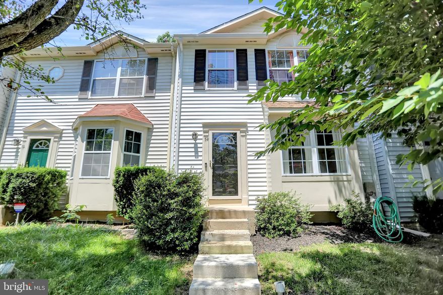 Lovely Colonial interior townhouse with 3 bedrooms, 2 full and 2 half baths offers ceiling fans, separate dining room, kitchen with breakfast room and center island, stainless steel appliances, chair rail, recessed lights, corner wood burning fireplace, primary bedroom with bathroom, deck and more! Updates include deck stained in 2021, washer and dryer new in 2020, chimney cap in 2019. Carpet, lower level and most of the upper level painted, lower level sliding glass door and vinyl floor in primary and upper level baths all in 2018. Kitchen and main level half bath updated, laminate floor, heat pump and roof all in 2014. All appliances included, 2 parking spaces convey, convenient to schools/shopping/commuter.  Camera on the exterior records video and audio