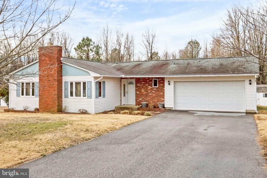 One level living on large .25+A lot!  Three bedrooms and two full baths.  The kitchen has 42 inch cabinets, tile backsplash and soft close drawers.  Newer Kitchen-Aid appliances in 2015.  Sun porch off of the family room with access to the partially fenced rear yard.   Separate living room with Harmon pellet stove, Separate laundry room, Attached two car garage with cabinetry and furnace room.  Newer well in past 2-3 years.  Multiple large sheds for storage, Crawl space with concrete and room to stand up!   There are hardwood floors underneath of the carpeting.  Paved driveway for multiple cars.  Great opportunity to own this home boasting pride of ownership! Multiple marinas minutes away!  Blue Ribbon Schools.