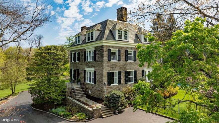 New price! We are excited to present 8523 Ardmore Avenue in Wyndmoor, a truly spectacular property, built in 1880, in the Victorian style. This magnificent, stone residence, beautifully sited on 2.26 acres, adjacent to the Wharton Sinkler Estate. The first floor features a brightly lit, gracious floor plan with exquisite architectural details and millwork, beautifully maintained. Enter the large entry hall with handsome staircase and fireplace; always a warm welcome for family and friends. Formal living room, dining room and a cozy library, all with fireplaces. Gourmet kitchen includes a large pantry and breakfast room opening onto deck with sweeping views of the property. Upstairs, in addition to a spacious  primary suite with fireplace, two floors of bedrooms, baths, offices and comfortable living spaces. Lower level offers mudroom, game room and wine storage. Outside, enjoy an entertainer’s dream, with a lovely pool, expansive terraces, firepit and mature landscaping, creating an extremely private setting within walking distance to the Wyndmoor and Chestnut Hill villages, schools, transportation and the Wissahickon trails. Quite simply, this is one of the area's finest properties, in a coveted location, ready to move right in.