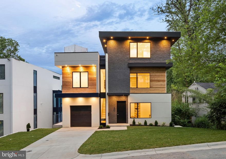 Exquisite contemporary masterpiece with great location in the heart of Bethesda
Contemporary architect-designed home for those who appreciate a modern aesthetic, open floor plan, pervasive smart home technology, and entertaining space. Floor-to-ceiling windows frame glorious views. This stunning home invites seamless indoor-outdoor living as you enjoy the private, expansive rooftop deck with the built-in Saber grill and luxury outdoor kitchen, and balconies for entertaining or relaxation on every level overlooking the neighborhood. The gourmet kitchen is a chef’s dream, featuring high-end appliances, oversized island, upgraded countertops, and custom cabinetry with abundant storage. Retreat to a luxurious primary suite offering a bay-front layout, spa-like bath with soaking tub and stall shower, and custom step-in closet. Wake up to amazing sunrises from your bedroom. Total of 5 bedrooms and 5.5 bathrooms. Built with sustainability and convenience in mind, this home includes ENERGY STAR appliances, dual flush toilets, high-efficiency water heater, Grundfos Comfort hot-water recirculation system, EV-ready garage wiring, and smart green features throughout. Entertainer's dream home with 3 wet bars. A glass-enclosed wine cellar, sauna, steam shower, and elevator are just some of the amenities. Top of the line appliances are in the chef’s kitchen, including built-in pizza oven and coffeemaker. Manage state-of-the-art Ubiquiti network, Lutron zoned lighting, Juke Audio zoned music streaming, Generac generator, as well as all kitchen appliances from your iPhone. Whole home surge protector included. Conveniently located in one of Bethesda’s most sought-after neighborhoods, within minutes of NIH, Walter Reed, the Beltway, Wildwood Village, Red Line Metro, and Bethesda Row. Awesome neighbors in all directions! Don't miss your opportunity to own one of Bethesda’s most stunning modern homes.