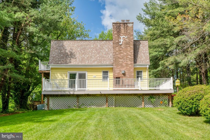 Set on more than 3/4 of an acre, this inviting custom-built home offers an inground pool, charming wraparound porch, and a versatile floor plan. The main level features a bedroom and full bathroom, perfect for guests or multigenerational living. Upstairs, the private suite has laundry for convenience and opens to its own deck through sliding glass doors. Pergo flooring flows through much of the main level, where you'll also find a kitchen, dining room, and living room with fireplace. The basement has plenty of space for extra storage, workshop, etc. Ideally located with convenient access to major commuting routes. No HOA. As Is sale.