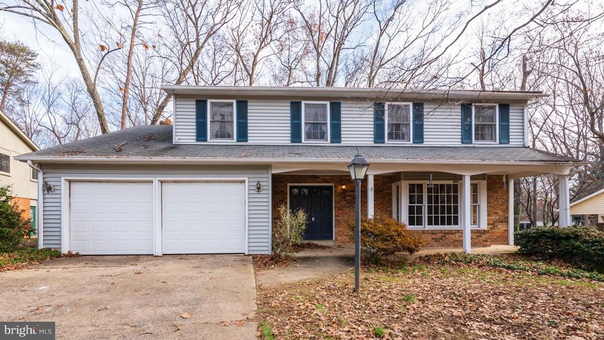 Wonderful curb appeal for this traditional  Colonial with front porch. Great price - needs some  updating, but great floor plan and beautiful wooded setting. Hardwoods throughout most of house, eat-in kitchen with convenient laundry room near by. Unfinished basement  with level side  walk out - to be used as you want!  Here's your chance to get into soughter Uplands neighborhood. Sold "as is"