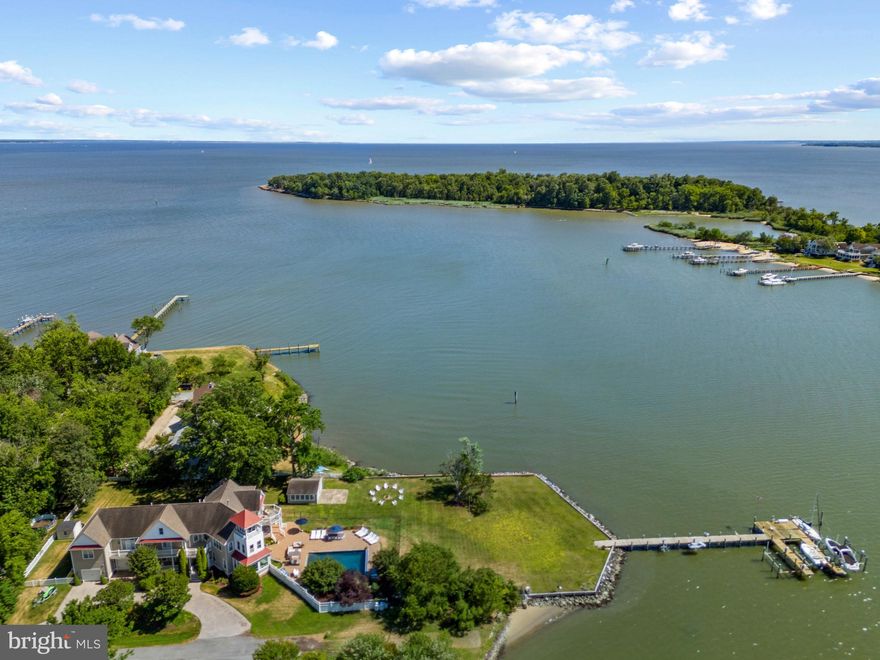 Waterfront Estate with Pool, pool house and private pier in Arundel on the Bay! Imagine summers spent poolside, where gentle breezes off Fishing Creek create the perfect setting for sun-soaked afternoons and starlit gatherings. At 1291 Hollywood Avenue, waterfront living is more than just a view—it’s an experience. Set on a spectacular 1.03-acre point lot with 280+ feet of shoreline, this private retreat offers endless ways to enjoy life on the water. Launch your boat from the deepwater pier with five slips and 8-foot MLW, crack open fresh crabs in the charming crab shack/pool house, or simply lounge by the waterside pool, soaking in the southern exposure and breathtaking panoramic views. Inside, over 6,700 square feet of thoughtfully designed space welcomes family and guests alike. The open-concept floor plan, Gourmet Kitchen with island, natural light filled window seat alcove and much more, offer a stunning backdrop for entertaining while provide the perfect blend of elegance and comfort. A main-level au pair or guest suite makes multi-generational living effortless, offering privacy and convenience. Upstairs, the luxurious Primary suite offers all the best in finishes and amenities including spectacular views, private balcony, and fireplace  The spa-like primary bath is stunning with soaking tub overlooking the water, walk-in shower, sauna and 2 vanites. The custom closet with washer and dryer is unparalleled!  Adjacent to the bedroom is a bonus room with endless uses and one-of-a-kind birds’ nest room provides a quiet escape, where endless water views stretch as far as the eye can see—a truly magical spot for reflection or inspiration.  The theater room, enormous playroom, wine cellar, mudroom with separate entrance, cozy reading nooks, and playful hideaways add to the home’s charm, ensuring every space is as functional as it is beautiful. Just five miles from downtown Annapolis with easy access to Route 50 and I-97, this extraordinary waterfront home is a true sanctuary where every day feels like a vacation. Welcome Home!