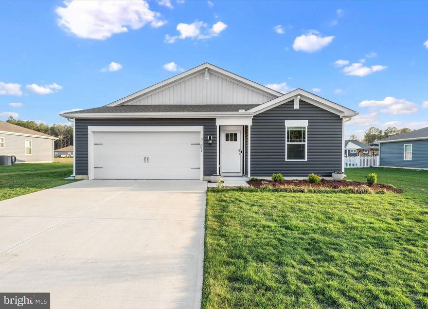 Welcome to 31564 Fountain Rd in beautiful Lewes, Delaware – where modern comfort meets low-maintenance coastal living! Built in November 2023, this like-new ranch home offers 3 bedrooms, 2 bathrooms, and a spacious 2-car garage. From the moment you arrive, you’ll be impressed by the home’s stylish curb appeal, featuring a modern façade with eye-catching board and batten accents and refreshed landscaping. Inside, the home has just been freshly painted throughout, complementing the open-concept floorplan, luxury vinyl plank flooring, and recessed lighting that create a bright and inviting atmosphere. The kitchen is both functional and elegant, complete with stainless steel appliances, a breakfast bar, and a pantry. The adjoining dining area features sliding glass doors that lead to an expansive paver patio – perfect for entertaining or dining outdoors. The fully fenced backyard, enclosed with sleek black iron fencing, backs to open common space. The spacious primary suite includes a walk-in closet and a private en-suite bath with LVP flooring. Two additional bedrooms and a second full bathroom provide flexibility for guests, a home office, or hobbies. Additional highlights include a tankless water heater, all appliances included, and modern conveniences like an electronic doorbell and keypad entry system. Enjoy a truly low-maintenance lifestyle in this amenity-rich community, where lawn care, snow removal, and trash service are all handled for you. Residents also have access to a community pool – perfect for summer days. Ideally located in the serene Lewes beach area, this home is just a short drive to Rehoboth Beach, downtown Lewes, and Dewey Beach, and less than 10 miles from the Tanger Outlets, shopping, dining, and more. Move right in and start enjoying coastal living at its finest!