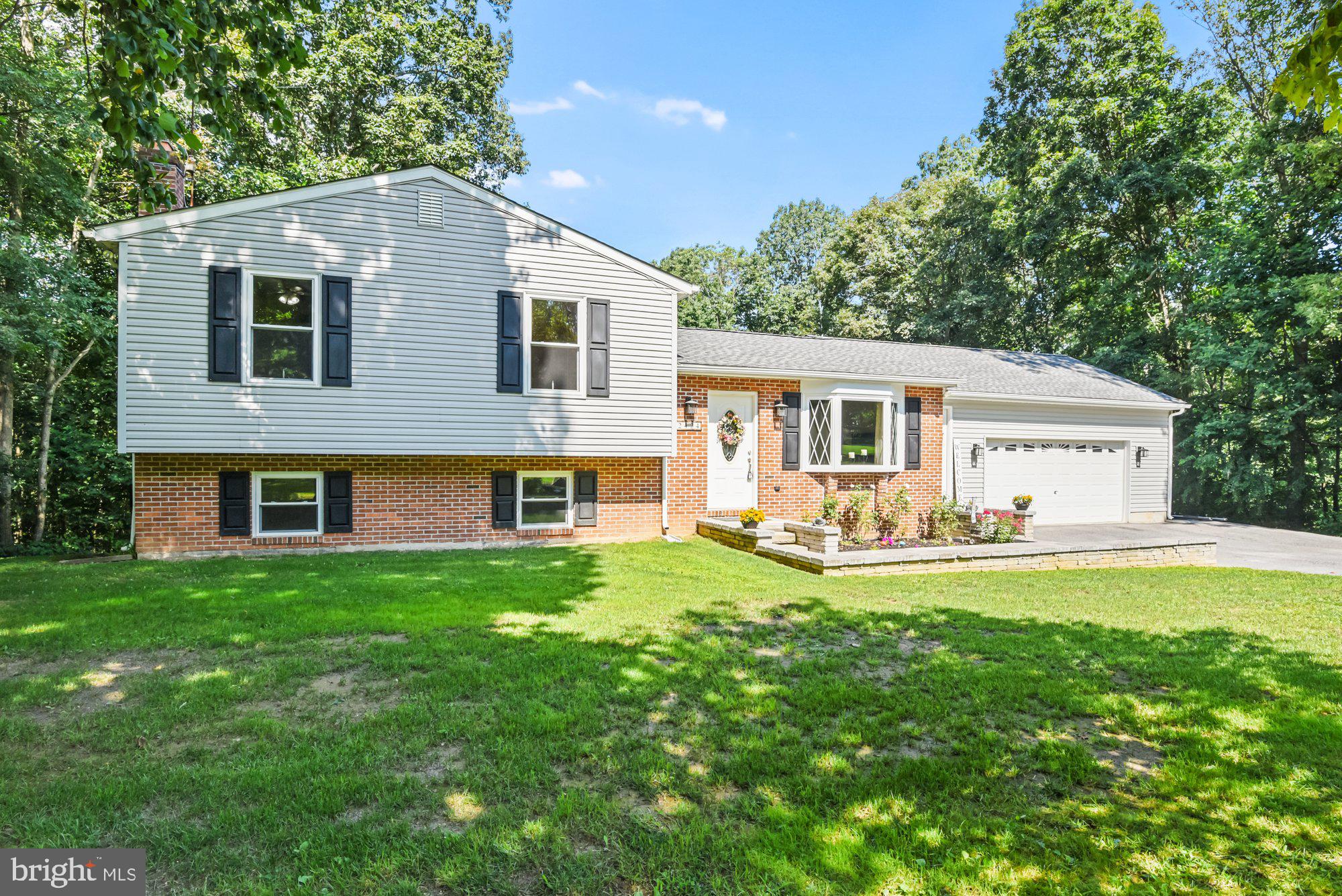 Come check out this gorgeous home!! This 4 bedroom, 3 full bath home sits on 2+ acres and offers lots of privacy. The main level features an open floor plan with a formal living space, hardwood floors, updated stainless steel appliances, and a separate pantry. The new washer and dryer are conveniently located on the main level! The dining room leads to your spacious deck with plenty of space for entertaining or relaxing! The lower level features 1 bedroom, 1 full bath & a family room with a separate entrance that leads to your private backyard. BRAND NEW roof installed July 2021 with a 50-year warranty, oversized 2-car garage, newer windows with a transferrable lifetime warranty, newer heat pump, updated electric, whole house generator rough-in, and storage shed big enough to store all your toys. This beautiful home boasts pride of ownership from top to bottom! Schedule your showing today!