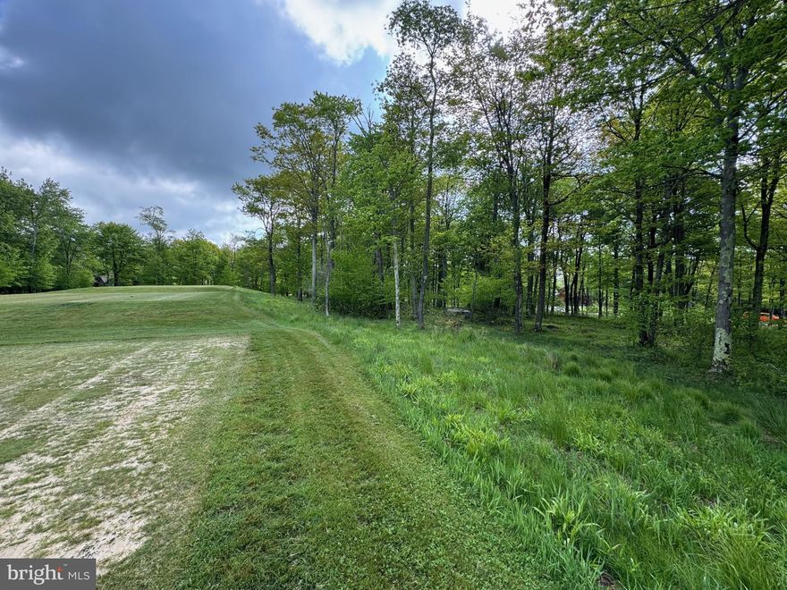 Golf course building lot. Beautiful wooded, gently sloping lot directly adjoining Hole 8 of Lodestone Golf Course atop WISP resort ski mountain situated above the shores of Deep Creek Lake. Small gated community with paved and private maintained roads. Lot positioning on cul-de-sac road assists with no through, and very minimal traffic otherwise. Very nice building lot for nearly any style of home. Public water, sewer, and electricity to lot. Attractive and inviting area and surrounding appearance around lot, and especially super nice scenery and atmosphere on rear of lot adjoining course. Membership and public play course. WISP ski slopes literally just a few minutes from lot, as well whitewater rafting circulating course, Deep Creek Lake, Youghiogheny River for rafting, kayaking, and trophy trout fishing, as well as Swallow Falls, Herrington Manor, and Deep Creek Lake State Parks only 10-15 minutes easy drive or bicycle ride away. "Great area for just living", but too, relaxing, dining, biking, golfing, skiing, boating, fishing, tons of public year-round events, and more than can list. Everything and more to like!