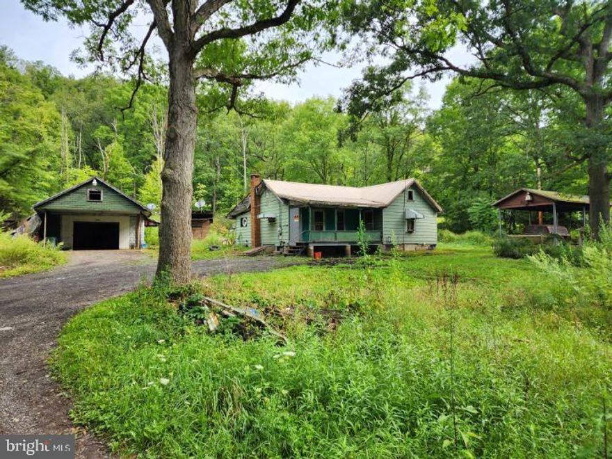 A beautiful, and secluded .59 Acre lot just minutes from town! Keep the structure and repair it or tear down and start fresh! Public water, private sewer and electric all on site. Public sewer is available. Come explore the possibilities!
