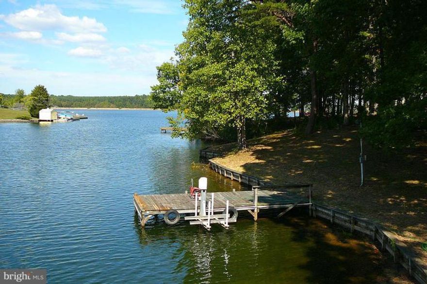 REDUCED!! UNDER TAX ASSESSMENT.  BEAUTIFUL waterfront lot, private cove, sea wall, dock with lift for aluminum boat or jet ski up to 1500 lb and ramp for boat,,,commanding views.  Soil letter on file 2-3BR.  Wooded lot with cleared building site.  Storage shed with electric, electric at dock! Still time to enjoy the lake! Waterfront 150 ft +-