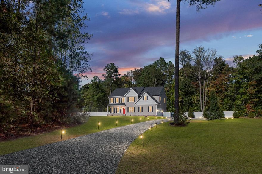 Welcome to a gated 10-acre luxury estate near Lake Anna with 5 bedrooms, 4 baths, and 3,332 square feet, where horses and livestock are welcome. Tucked within Brooke Ridge Estates, this pristine retreat offers room to breathe with effortless access to Fredericksburg. The home feels practically new, with thoughtful upgrades, fresh finishes, and true turnkey comfort. On the main level, enjoy a formal dining room, a formal living room or home office for flexible work or lounge space, and a large living room that opens to the airy eat-in kitchen, perfect for gatherings. The kitchen features dual refrigerators, recent appliance updates, and a classic farmhouse sink, while storage shines with large, customized closets and a generous pantry throughout the home. A main-level guest bedroom and full bath add easy multigenerational living or convenience for weekend guests. Nearby, the laundry room includes a 2025 high-efficiency washer and dryer and custom shelving, with direct access to a whisper-quiet two-car garage with built-ins. Upstairs, updated luxury vinyl plank flooring leads to a grand primary suite with two walk-in closets and a spa-style bath with a sunken tub, double vanity, and walk-in shower, enhanced by refreshed lighting and fixtures. An adjacent bedroom enjoys its own ensuite, while bedrooms three and four share a double-vanity bath. Each secondary bedroom includes a walk-in closet and custom window treatments. Outside, the property is as beautiful as it is functional. All ten acres are fully fenced and newly landscaped with fourteen young trees. A Pennsylvania blue slate walkway, steps, and front porch create a timeless first impression with brick trim panels for added character, while solar motion-sensor lighting gently illuminates the grounds. Everyday organization is easy thanks to a double-door shed with pine shelving, a garden tool organizer, and a vinyl-fenced enclosure that neatly screens trash receptacles. A gravel driveway with a convenient garage bump-out and front turnaround, plus a quiet power-lift garage door motor and custom garage shelving with a wall-hanging system, keep life running smoothly. As evening falls, gather at the inviting fire pit and enjoy star-filled skies, the perfect finish to a beautiful day in the country. With the 10-acre lot, the possibilities are endless. Bring your horses and plan simple paddocks and a tidy run-in, and lean into the country lifestyle with gardens, trails, and long porch mornings watching the sunrise over your own land.