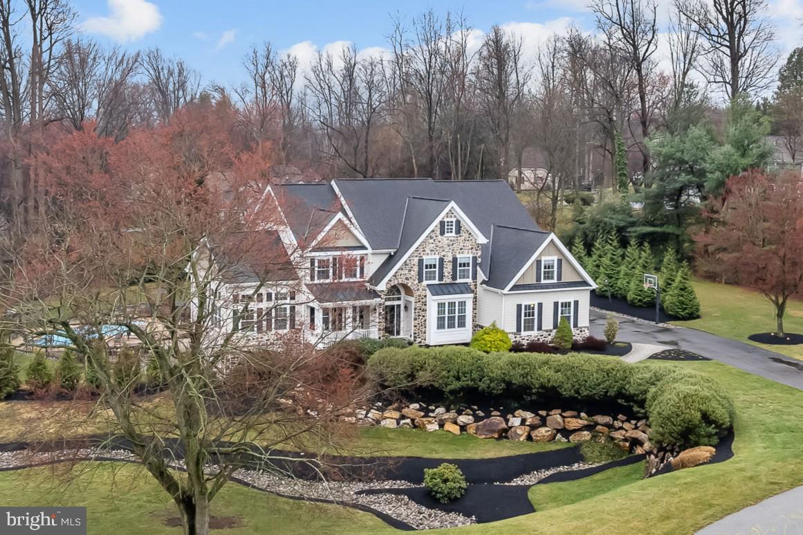Welcome to this exceptional 6-bedroom, 4.5-bath home in the prestigious Middleton Greene community of Landenberg. Located on a magnificent 1-acre lot, a unique and special feature of this property is that it boasts both public water and public sewer. Perfectly positioned to overlook the community pond, this home is the epitome of luxury, offering impeccable craftsmanship, high-end finishes, and an outdoor oasis that rivals a five-star resort.
Step into the grand two-story foyer, flanked by a sophisticated study with built-ins and a formal living room with elegant wainscoting. Gleaming hardwood floors flow seamlessly throughout most of the home, adding warmth and refinement to the thoughtfully designed layout. The formal dining room provides the perfect setting for entertaining, while the light-filled conservatory offers a peaceful retreat.
At the heart of the home is the breathtaking two-story family room, where a floor-to-ceiling stone fireplace, custom built-ins, and a graceful rear staircase create an inviting space for gathering. This spectacular room opens to the chef’s kitchen, a true culinary masterpiece featuring granite countertops, stylish 42” cabinetry, a large center island with seating, farmhouse sink, tile backsplash, pantry, and premium stainless-steel appliances—including a gas cooktop and double wall ovens.
Adjacent to the kitchen, the informal breakfast room is both elegant yet functional, boasting a serving area with built-ins and walls of sliding glass doors that lead to multiple decks. From here, step down to the paver patio and the absolute outdoor oasis beyond—a heated saltwater pool with a sun shelf and multiple entertaining areas, creating the perfect backdrop for unforgettable gatherings.
Upstairs, the owner’s retreat is a private sanctuary, offering a spacious bedroom with a sitting room, double walk-in closets outfitted with custom built-ins by California Closets, and a spa-like bath complete with a double vanity, oversized soaking tub, and a seamless-glass tiled shower. Three additional bedrooms complete the upper level, including one with a private en-suite bath, while the other two share an adjoining bath.
The finished lower level is truly magazine-worthy, featuring a recreation area, second family room, stunning wet bar, full theater, exercise room, two bedrooms, and full bath—perfect for entertaining or hosting overnight guests.
Additional highlights of this one-of-a-kind home include a three-car garage, impeccable landscaping, public sewer, and a long list of premium upgrades, including Hardie exterior siding, a newer roof, a whole-house generator, high-end built-ins throughout, and brand-new Ferris decks with stylish cable railing leading to the heated saltwater pool and surrounding patio.
Located just minutes from restaurants, shops, athletic centers, schools, and major commuting routes, this extraordinary home is a rare opportunity to own a true showpiece in one of Landenberg’s finest communities.