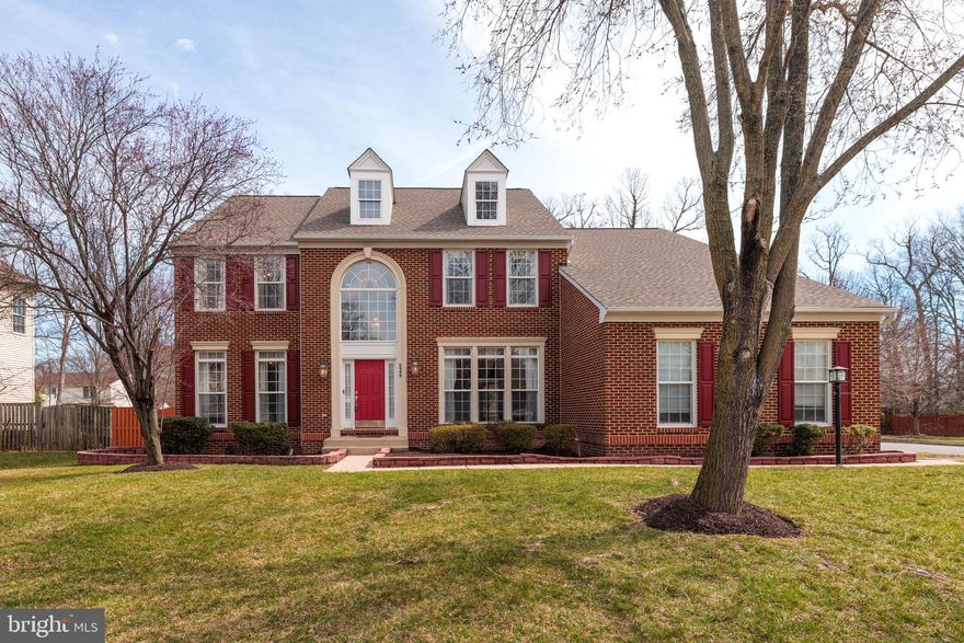 Welcome to 6999 Caton Woods Court, a gorgeous brick-front Middleburg model with a side-load three-car garage and a modern open floorplan in Springfield’s desirable Caton Woods. This large colonial is sited on a flat over a third of an acre lot on a quiet cul-de-sac and has a huge fully-fenced backyard. Two dormer windows add a touch of class to the front elevation. The two-story foyer is impressive with its massive Palladian window! There are classy refinished hardwood floors on the main level, stairways and hall on the upper level. The living and dining rooms are distinguished by high ceilings and extensive and elegant moldings. There’s a triple window in the dining room. The main level office is perfect for working from home! With the main-level full bath, it could also be used as a bedroom. The kitchen has rich cabinetry with some glass doors and wine storage, white tile backsplash, granite counters, a large useful island, a new dishwasher, a desk area with cubbies and lots of recessed lighting. A refined granite-topped butler’s pantry between the kitchen and dining room makes for smooth entertaining. There’s an awesome family/great room with an inviting gas fireplace with a marble surround and detailed wood mantel flanked by high windows.You’re sure to enjoy the cheerful sunroom off the kitchen with four skylights, recessed lights, walls of windows and pretty views of the rear grounds. Step out from the sun room to the paver patio - a perfect place to grill out and spend time with guests! The backyard has curved paver retaining walls and lovely landscaping. The main HVAC is new, the upper unit was new in 2024 and the hot water heater was new in 2023. Take your choice of dual staircases to the upper level where new carpet has been installed in the four very spacious bedrooms, each of which has a ceiling fan. The extraordinary owner’s suite has a tray ceiling, wall of windows, stately columns, two walk-in closets and a sitting room. The owner’s bath has a soaring cathedral ceiling, dual vanities, a jetted Jacuzzi deep-soaking tub, separate shower with sliding glass doors and two linen closets. The lower level features an enormous rec room with ceramic tile flooring, lots of recessed lights and two other bonus rooms that could be a gym, media room or whatever your imagination comes up with. There’s also another full bath with a marble floor and the rec room walks up to the rear yard which also has a storage shed. This fine residence is super-close to Metro, all commuter routes, two town centers and more!