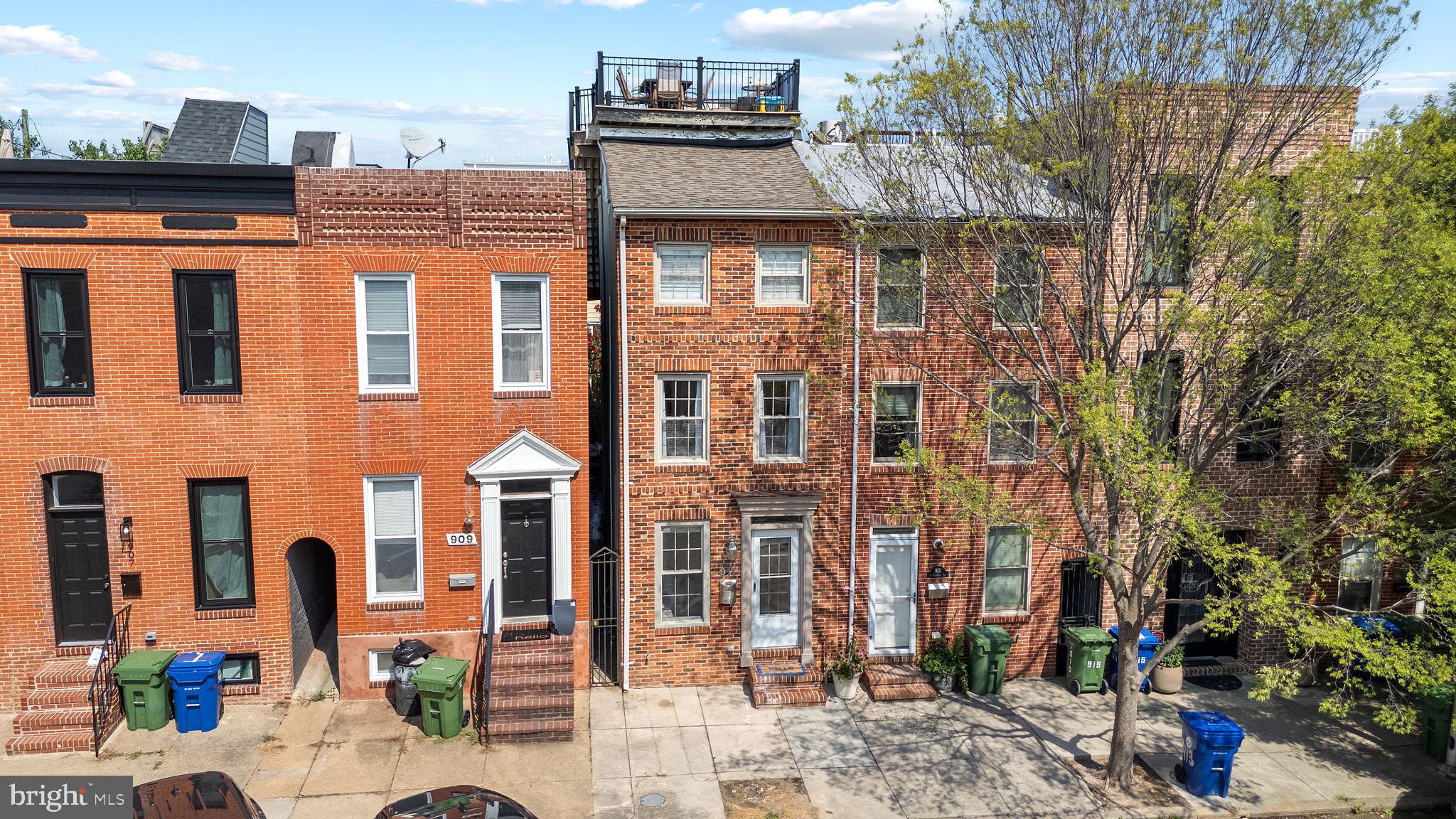 Welcome to this exceptional three-level home located in the heart of Baltimore's vibrant Canton neighborhood. Offering 2,160 square feet of meticulously updated living space, this property perfectly blends contemporary style with historic charm. Enjoy all the modern amenities you could desire, including a gourmet kitchen equipped with stainless steel appliances, elegant granite countertops, exposed brick accents, fireplace, hardwood floors throughout, and custom lighting complemented by abundant natural light from skylights. This spacious residence boasts four bedrooms and two and a half bathrooms making it great for a family or rental income. The custom-designed staircase railing adds a sophisticated touch, leading you to an inviting roof deck, perfect for gatherings or quiet evenings, with stunning panoramic city, sunsets and water views. Situated on a charming street only three blocks from the waterfront and 1 block from Canton Square.