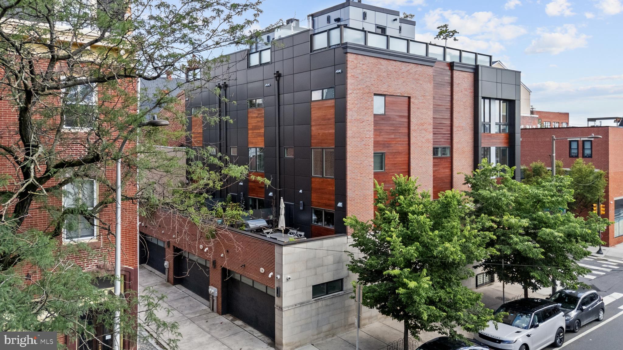 Welcome to the pinnacle of refined city living. This corner townhome is situated in the heart of one of Philadelphia's most coveted neighborhoods, Fitler Square. Offering nearly 5,800 square feet of indoor/outdoor space spanning across six levels, accessed by a private six-stop elevator. The rooftop deck is fully loaded with a hot tub, outdoor kitchen, and sweeping panoramic views. Plus parking for 3 cars! Meticulously crafted in 2015 and thoughtfully enhanced by the current owners in 2020, every inch of this home reflects timeless elegance, advanced smart home technology, and top-of-the-line finishes.
Step into a foyer-level entry with immediate access to the two-car garage (with two bike lifts), plus an additional third parking pad thanks to the private driveway. A powder room, plus coat and storage closets complete the entryway floor. The lower level features a high-tech media room with projector, retractable screen, wet bar, theater seats, custom AV control room, including a full guest bath and flexible guest bedroom or office with custom built-ins. The main level boasts a floating staircase, dramatic double-height ceilings, and floor-to-ceiling windows that soak the space with natural sunlight; privacy will be no problem thanks to the Hunter Douglas automated Silhouette shades. The gourmet kitchen includes a Wolf six-burner gas range/oven, Sub-Zero refrigerator and beverage cooler, Wolf microwave/convection oven, Bosch dishwasher, Brizo faucet, and custom cabinetry. The open floor plan flows into the dining area overlooking the living room and creates cohesion for everyday living and hosting alike. A secondary, private outdoor space is immediately off the kitchen, equipped with a gas BBQ and seating.
Upstairs are two spacious guest suites, each with their own walk-in closets and en suite bathrooms, plus a laundry room and office nook. The entire fourth floor is the owner’s suite with two walk-in dressing closets (one with a laundry chute), motorized blackout drapes, and a spa-inspired primary bathroom featuring a soaking tub, oversized waterfall shower with jets, heated towel rack, three Robern medicine cabinets, and a private water closet.
The top floor is a fully built-out pilot house leading to the roof deck - a true city oasis including a hot tub, outdoor TV, fire pit, garden planters with irrigation, and outdoor kitchen with built-in BBQ, ice maker, and refrigerator. Relax and enjoy the unobstructed views from the iconic Philadelphia skyline, to the Schuylkill River, from Billy Penn to UPENN, and the South Philly stadiums.
Additional features include: Dual-zone HVAC (4 zones total), smart home automation for climate, blinds, lights, water, cameras, security, and even the mailbox! Fanimation 84" ceiling fan, designer lighting, including a Trento chandelier. Flood/Water sensors, water softener, upgraded AV infrastructure. Available fully furnished with high-end custom pieces and designer furnishings. Greenfield School catchment! Over one year remaining on Philadelphia tax abatement (buyer to verify) and No HOA or association fees!
Perfectly situated between Rittenhouse Square and the Schuylkill River Trail, steps to UPenn, CHOP, and top local favorites like Rival Bros Coffee, Café Lutecia, Di Bruno Bros, Pizzata Pizzeria, and the Fitler Square Farmers Market. And conveniently located to PHL and 30th Street Station, and just a few blocks to Wawa, CVS, and Amazon Hub Locker.
This is more than just a home — it's a lifestyle.