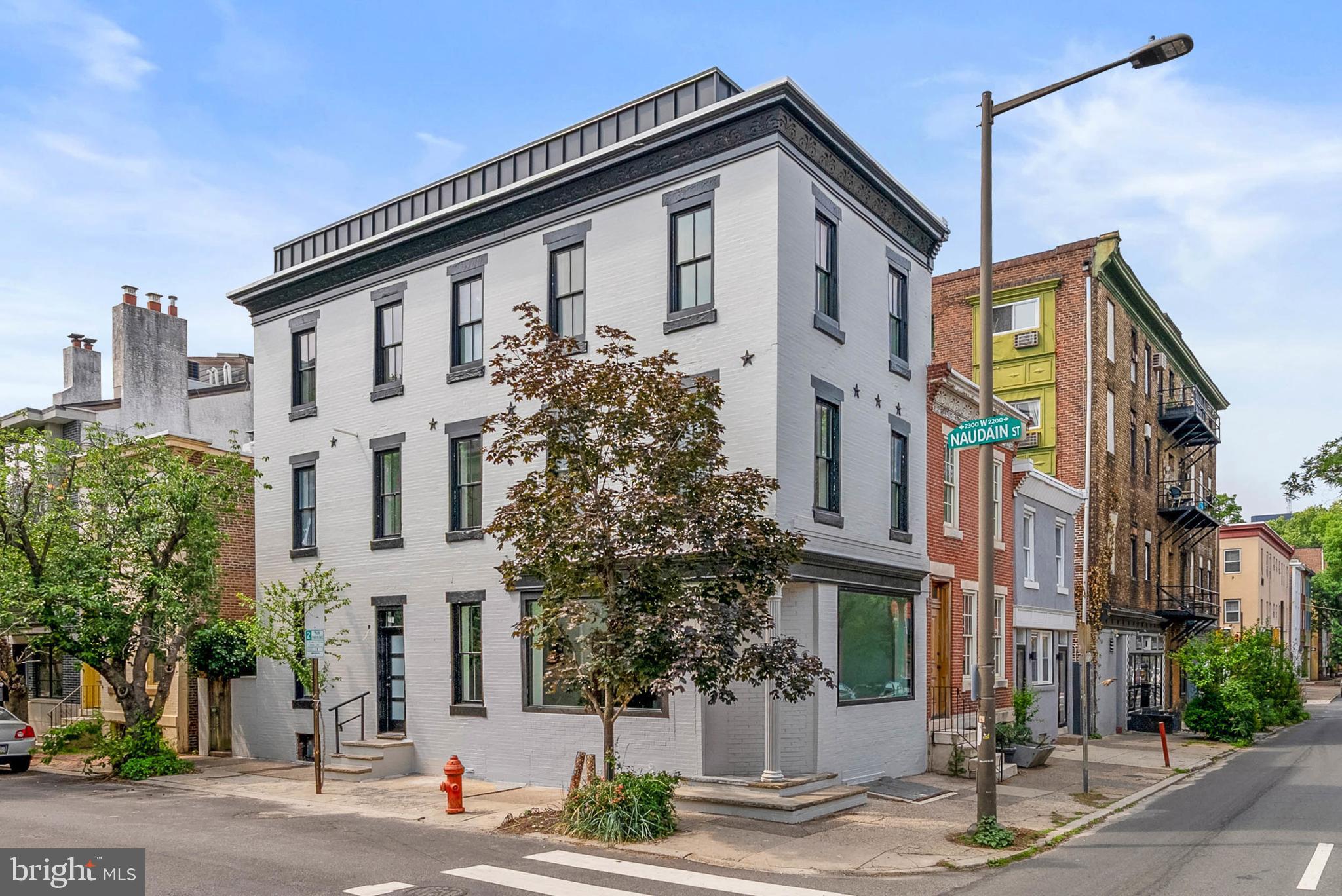Welcome to this corner masterpiece in Fitler Square. 2301 Naudain was exceptionally designed by AIA award winning Architectural firm LO Design. This residence sits on an 18' foot wide lot and features Top of the Line finishes, Pella Historic windows, a corner brick facade, Herringbone White Oak floors, a Showcase Floating Staircase, and unobstructed rooftop view of the Philadelphia Skyline. 2301 Naudain features 3 spacious bedrooms and 2 full bathrooms; with an option to add a 3rd bathroom and finish the basement. This custom floor plan maximizes every ounce of natural light through oversized windows. The first floor is located on the charming, quiet block of Naudain Street. Walking in through the entrance will make an immediate impression as the kitchen highlights a sleek European Kitchen (imported from Spain), Sub Zero & Wolf appliances, Stone upper cabinets and a central island with Mitered Waterfall edges. The Porcelanosa kitchen has a Panel Ready Sub Zero refrigerator, 5 burner Wolf cooktop, Wolf wall oven, a panel ready dishwasher and pantry. The living room stands out with 10 foot ceilings, White Oak floors that were finished on site along with oversized Pella Windows that maximize natural light. The first floor has a personal HVAC zone all for itself. The 2nd level has 2 guest bedrooms with Custom Closets. The washer/dryer is strategically located here for functionality. The third floor Primary Suite is the Crown Jewel of this home. This level has 8 foot tall solid core doors, office/de and one of the largest custom closets you will see in the City. The spa-like bath features heated floors, a Walnut Vanity along with Calcatta Viola tile and Kohler Components fixtures. No detail was spared with floor to ceiling tile. There is an option to add a Custom Fireplace and Wet Bar. The 4th floor landing offers a skylight and glass enclosed windows to shine light down the staircase and middle of the house. The rooftop deck is finished with a TPO roof and ultra high end Matte Black standing seam metal which compliments the sweeping views of the City's beautiful skyline. This residence comes with a FULL 10 YEAR TAX ABATEMENT.