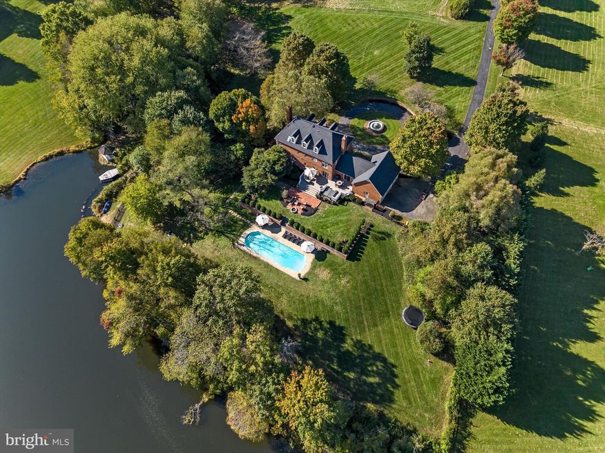 Stately all-brick custom home on 10 acres with a pool, lake frontage and access, fishing.  Located in desirable Philomont between Purcellville and Middleburg, rare non-HOA with lake privileges.  Grand circular drive with fountain.  Brick paver walkways and retaining walls, mature trees and landscaping.  Four levels with 5 bedrooms, a main-level study and finished walkout lower-level with a 2nd kitchen perfect for an au pair or in-law suite.  Spacious family room with wood-burning fireplace.  Deck with hot tub leads to paver patio, fire pit and pool.  Primary bedroom with hardwoods and wood-burning fireplace.  Private, rare lot amongst high-end custom homes. XFinity high speed internet.