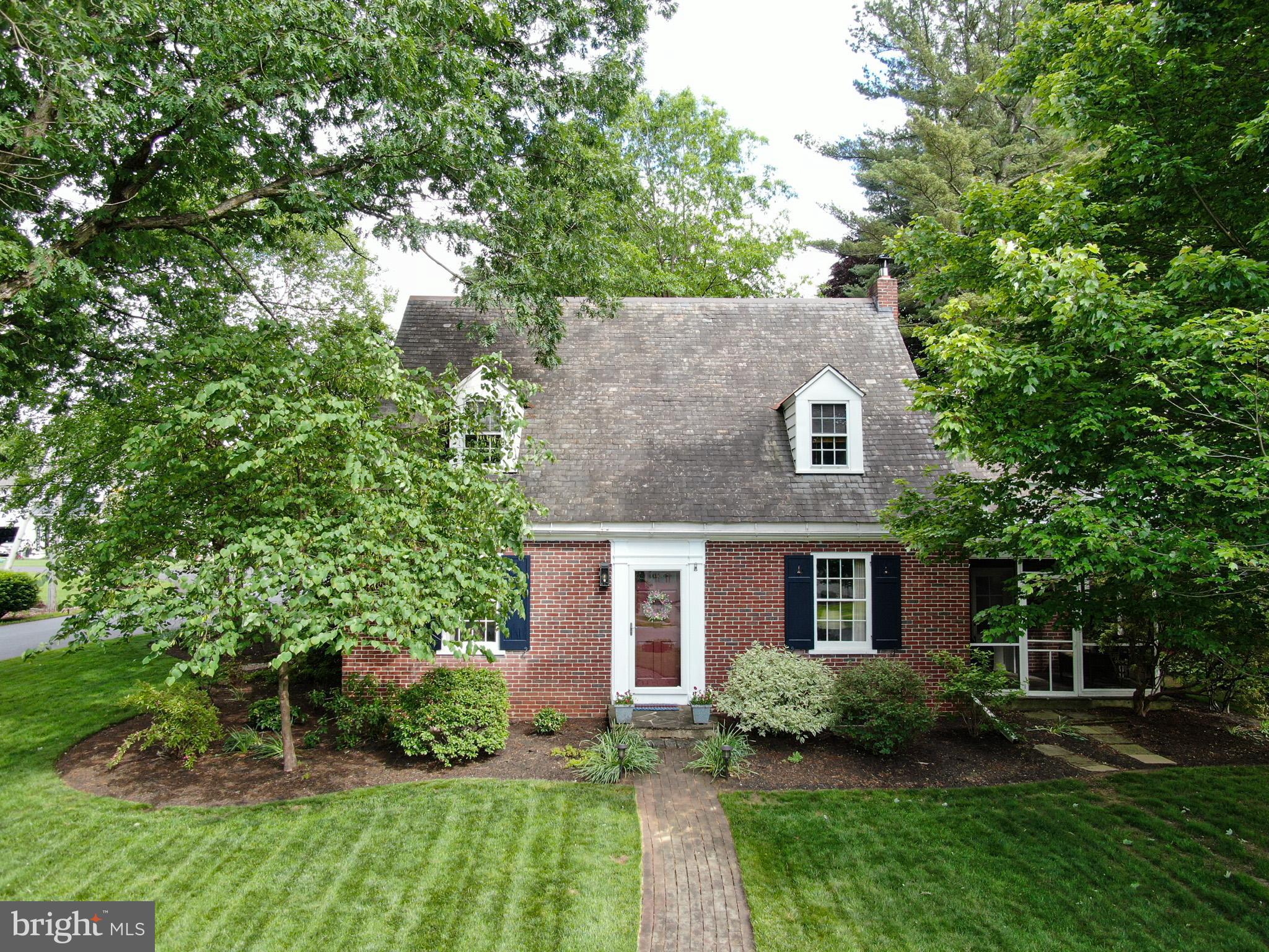 Charming all-brick Cape Cod on a manicured corner lot in desirable Manheim Township! This well-maintained home features 3 bedrooms, a remodeled full bath and powder room, gleaming hardwood floors, and a beautifully updated kitchen with granite countertops and a double oven. The formal dining room is perfect for gatherings, while the living room offers a cozy fireplace and built-in bookshelves. A screened-in porch and a versatile den or office add to the home’s appeal. Upstairs, the spacious primary bedroom includes his and hers closets and attic access. The second bedroom also features his and hers closets, a window seat, and a door to the balcony, while the third bedroom and a bonus sitting room complete the second floor. The improved basement includes a finished bonus room, laundry area, and ample storage. Enjoy outdoor living with a backyard patio and newly paved driveway leading to the attached garage. The sellers are offering a one-year home warranty and be sure to check out the full list of recent improvements!