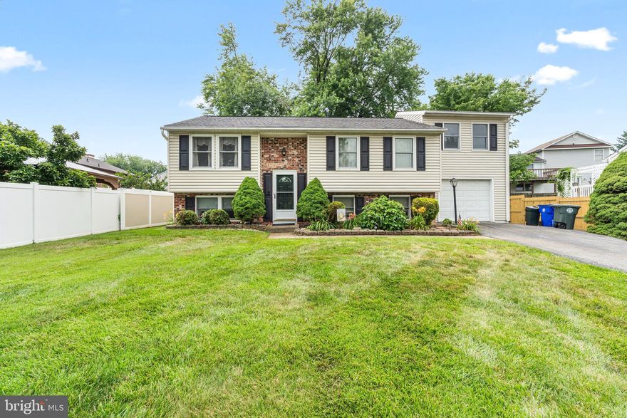 Tucked in a quiet cul-de-sac in Hillcrest Orchards, 497 Sulky Ln welcomes you with blooming daylilies and lush landscaping. This classic split-foyer features a seamless flow from the living room to the dining area, which connects to the kitchen and leads out to a back deck overlooking the fenced backyard. Head down the hallway past a full bath, the primary bedroom with walk-in closet, and a second spacious bedroom, then continue up to the addition with two more bedrooms to complete the upper level. The lower level includes a spacious rec room, fifth bedroom, second full bath, and a laundry/workroom with exterior access. Note the 50-year guaranteed roof (2016), leaf guard gutters (2017), newer siding (2018), rear drainage system (2023), and solar hot water system with two water heaters (2017). Lovingly maintained by the same owners for 45 years, this home is ready for your personal touches. No HOA, close to schools, parks, shopping, and commuter routes. Welcome home!