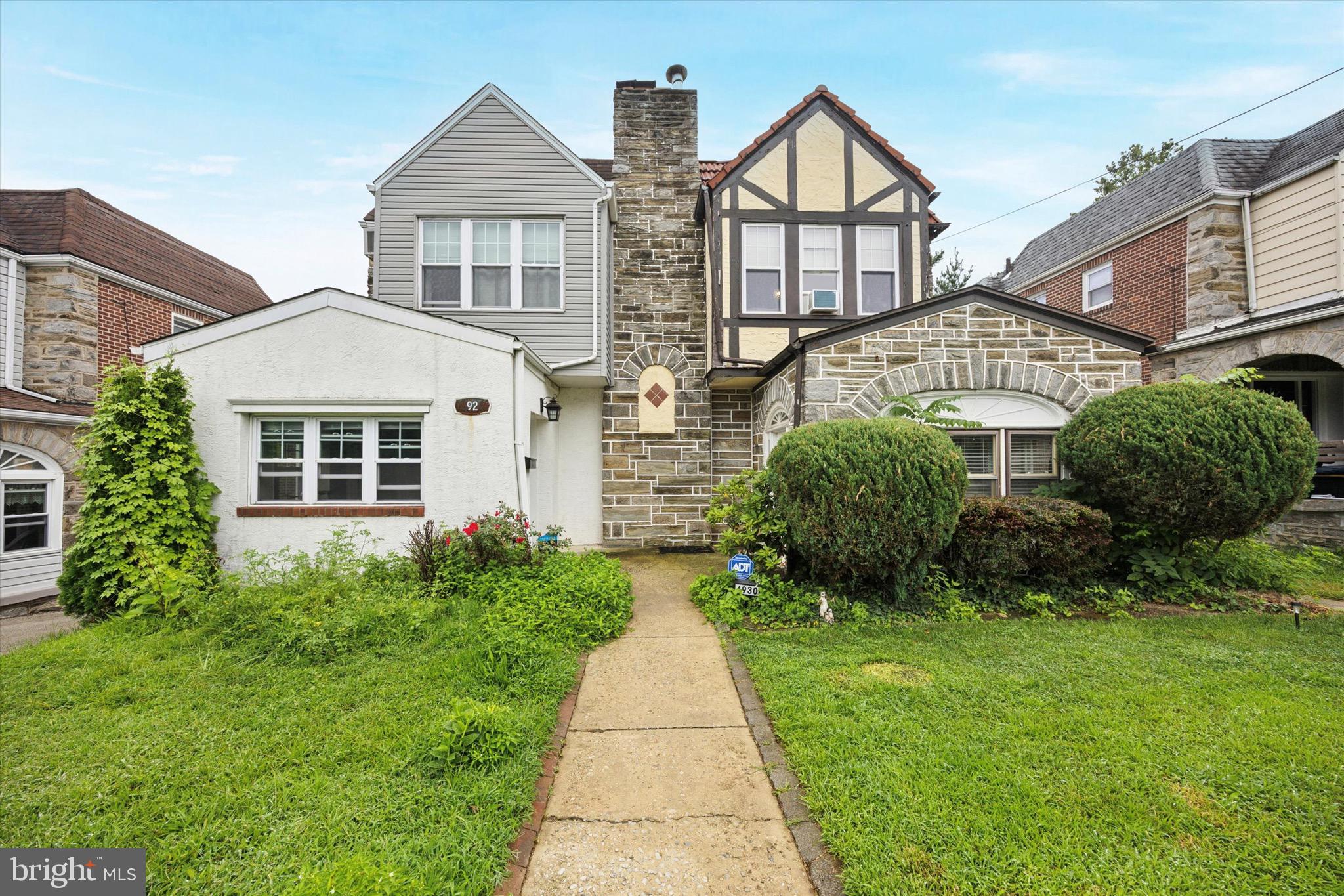 Welcome to this Beautiful 4 Bedroom 2 Bathroom Tudor Style Twin Home in Drexel Hill! Garage with Carriage Style Doors and a shared Driveway! This Home Checks All of the Boxes! Hardwood Flooring Throughout and Recessed Lights! FIRST FLOOR FEATURES: Enclosed Stone Porch with French Doors, Large Living Room with Stone Fireplace, Dining Room with coat closet, Kitchen with Granite Countertops, Peninsula, and Stainless Steel Appliances. Kitchen Leads to an Expansive Covered Balcony with views of the Rear Yard. SECOND FLOOR FEATURES: Primary Bedroom with Ensuite with Two Large Closets and tons of Natural Light. You will also find Three additional Bedrooms, another Full Bathroom, and a Hallway Closet. Basement features Laundry area with the convenience of a Walkout Exit/Entrance! Bring your vision as the unfinished Basement has Plenty of Space to add a 5th Bedroom as the options are endless! Step outside and Enjoy the Summer nights in the Large Private Back Yard which is Perfect for Entertaining! Easy access to major roads, shopping, transportation, Philadelphia International Airport, Chop Primary Care Drexel Hill, Playgrounds, and Schools. 1 Year Home Warranty Included! Showings Start this Saturday!!! Schedule your tour today!